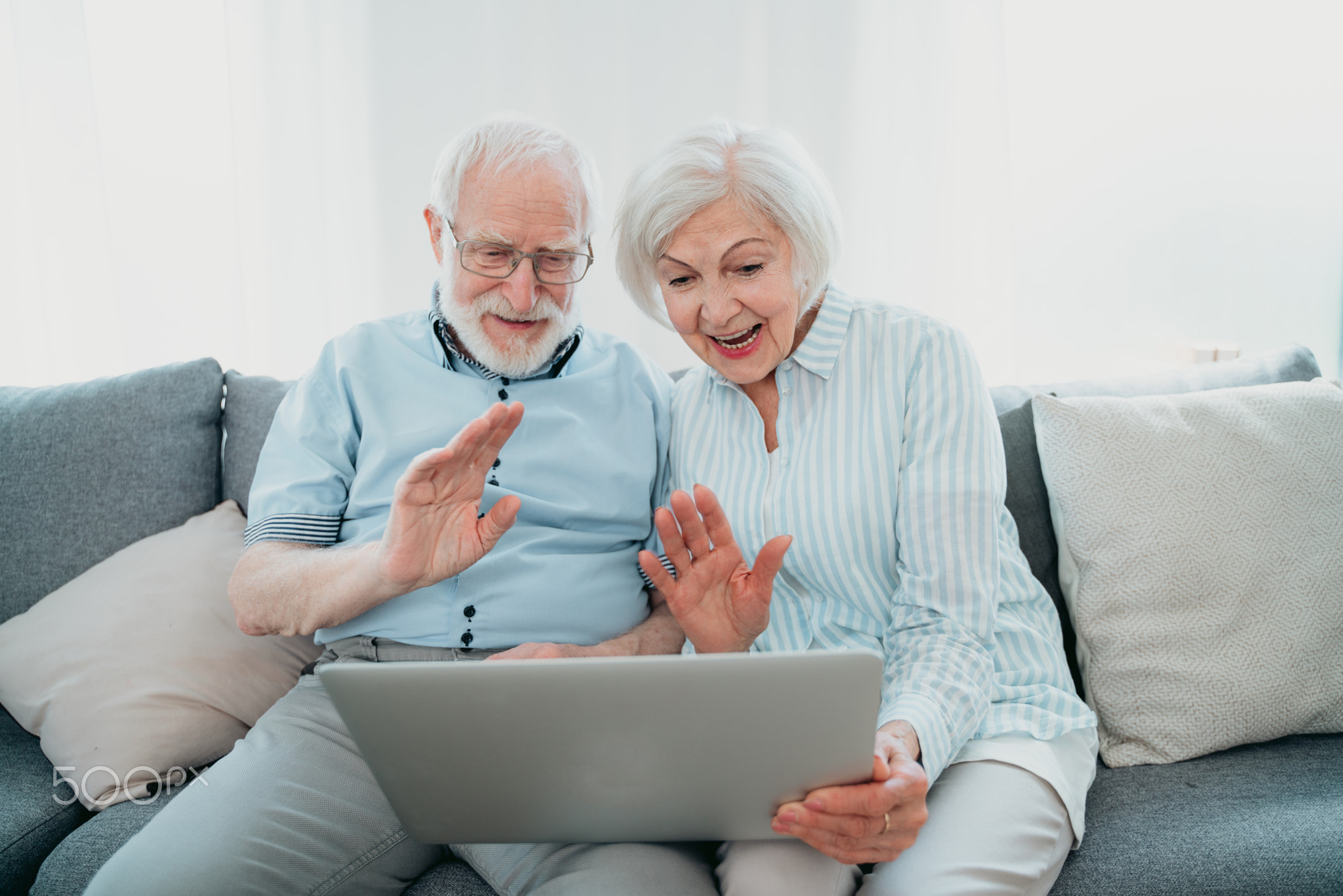 Elderly couple with computer laptop at home