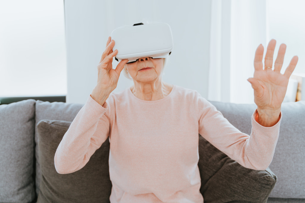 Senior woman playing with VR at home by Fabio Formaggio on 500px.com