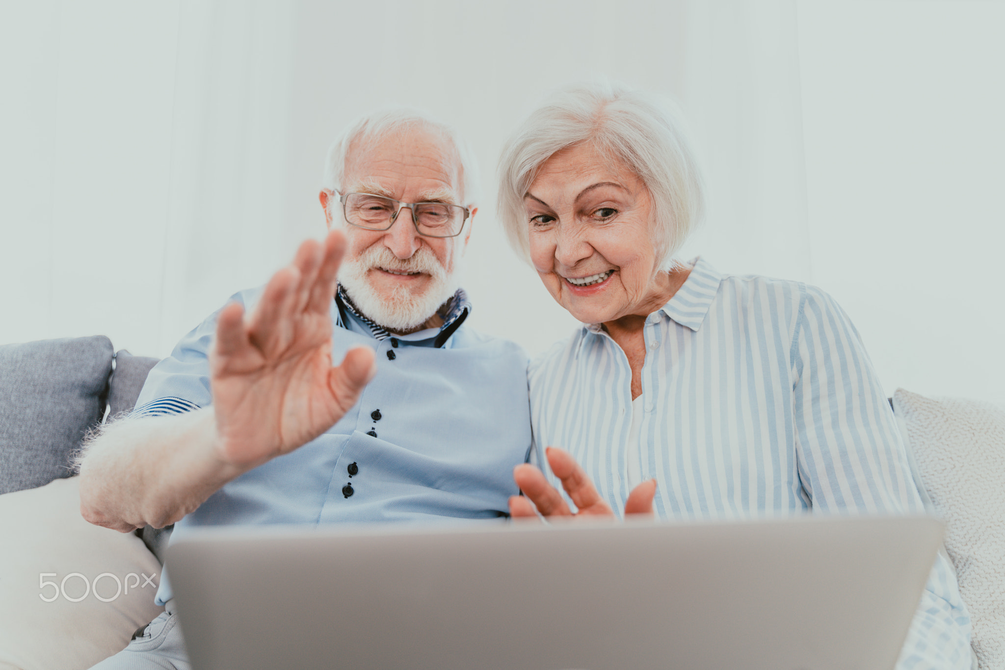 Elderly couple with computer laptop at home