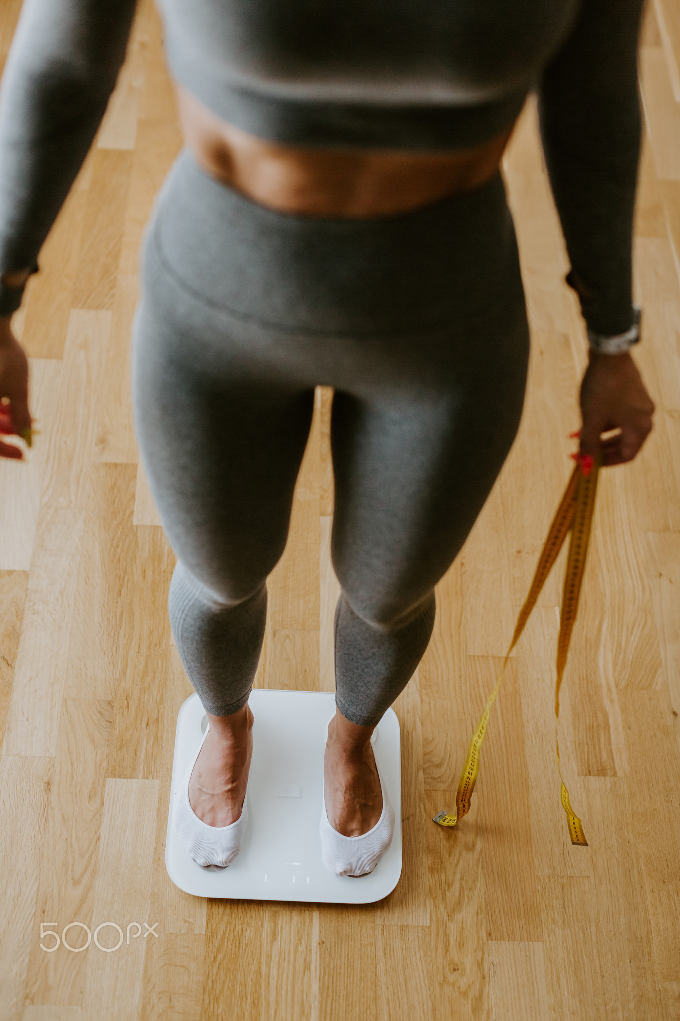 Woman Measuring Body Weight At Home. weight loss control