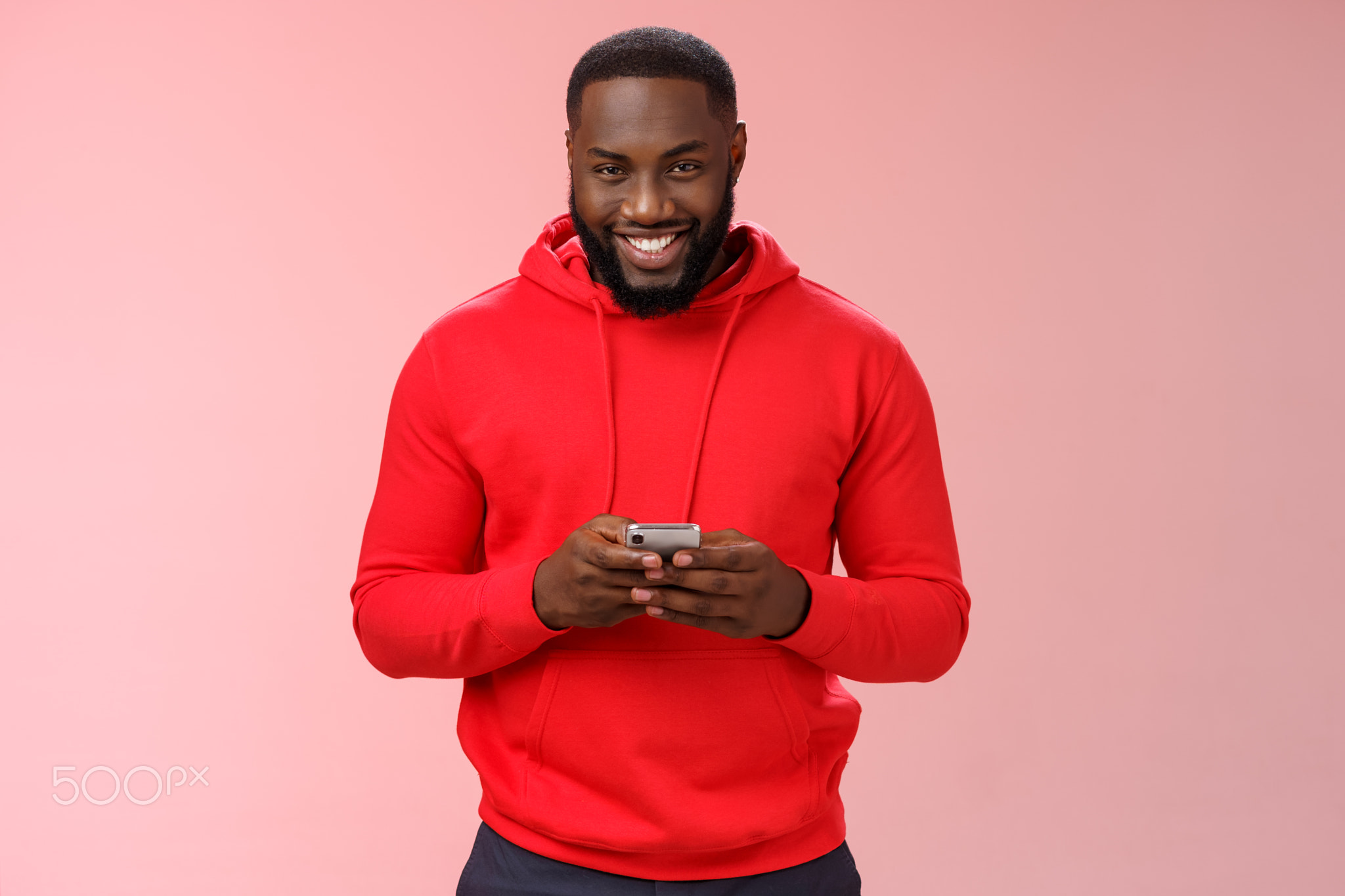 Attractive happy smiling african american bearded guy in red hoodie
