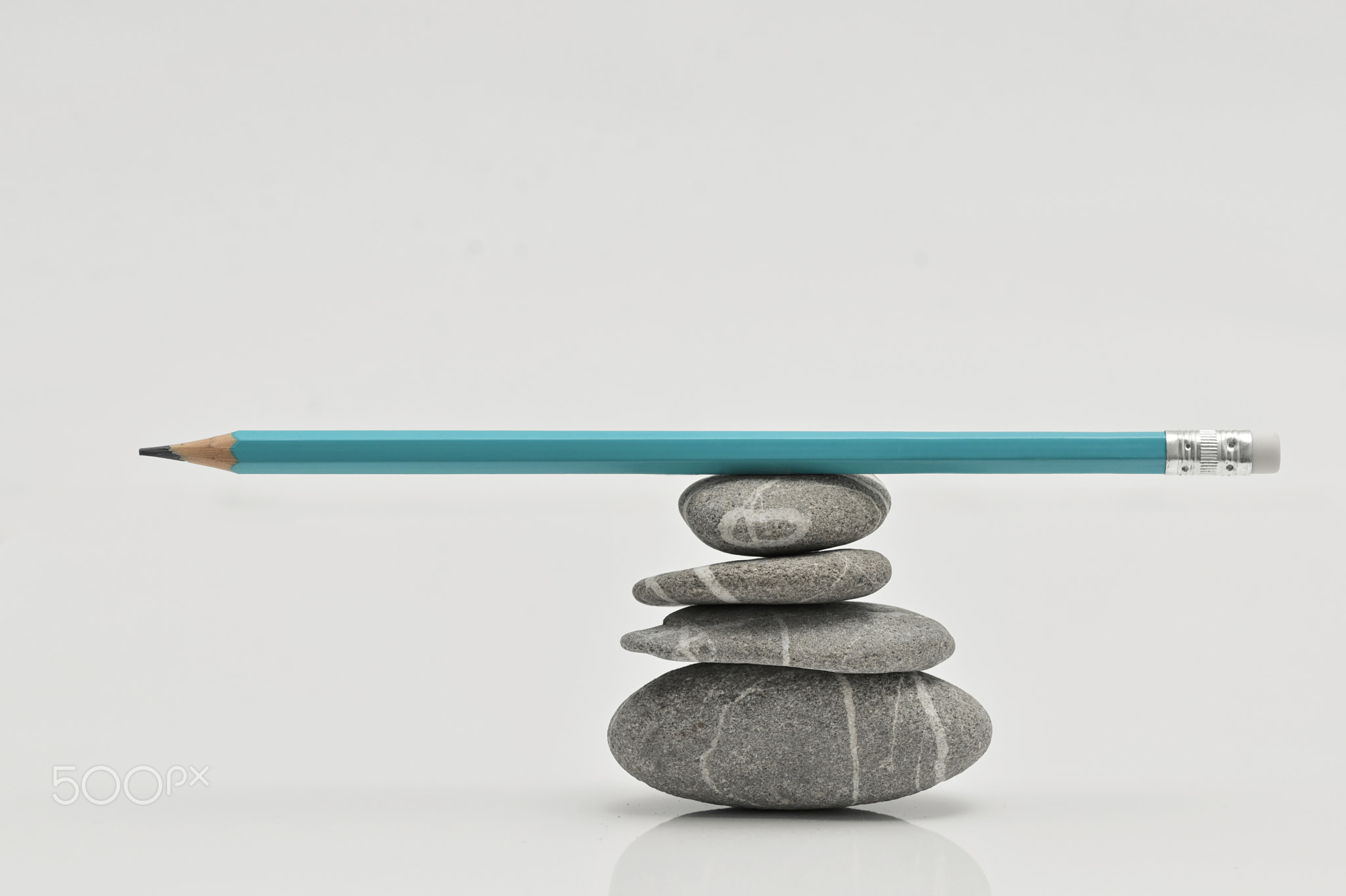 Balanced Writer concept. Pencil on Stack of pebbles