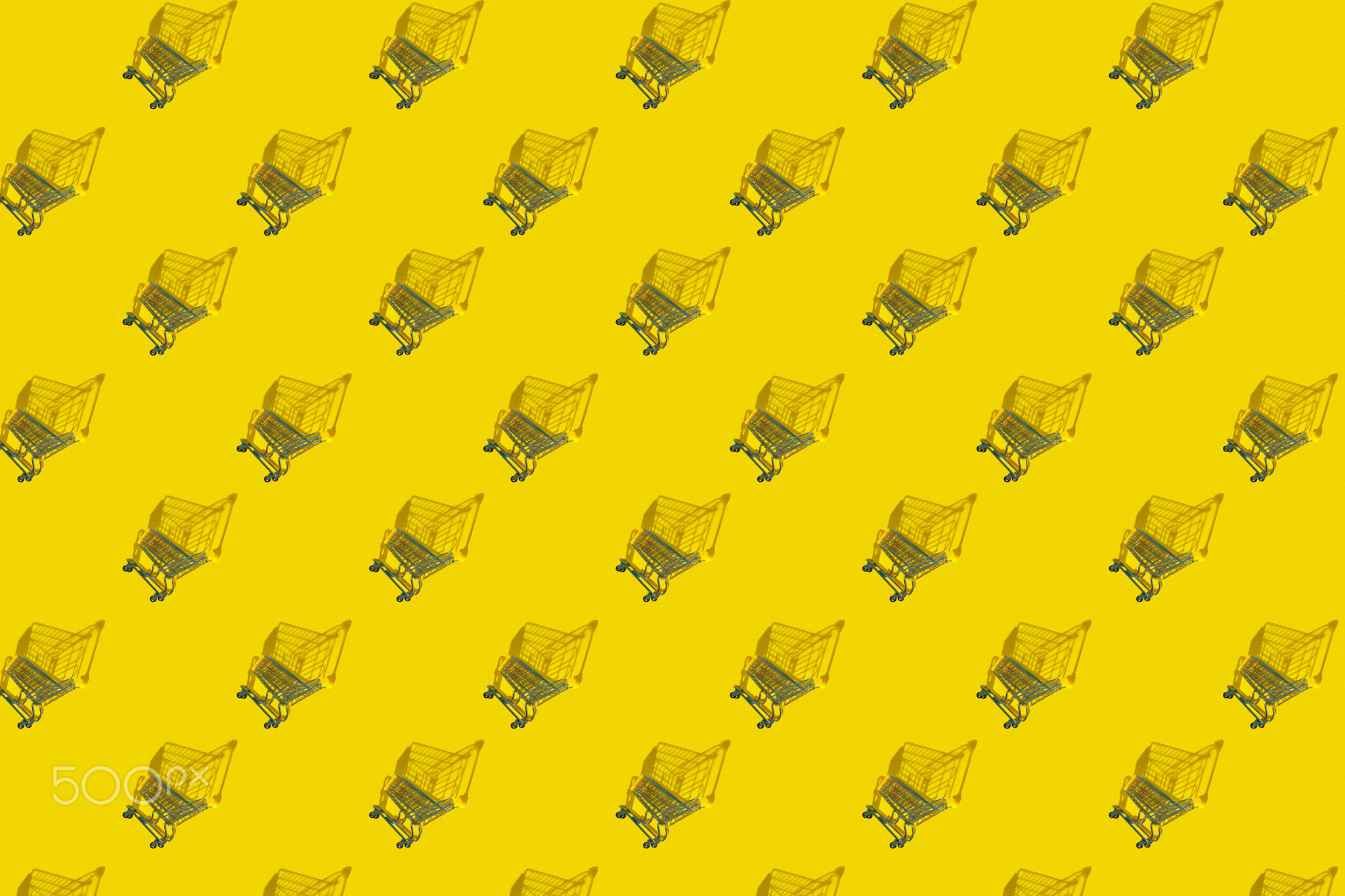 Cart from a supermarket on a yellow background pattern from the photo