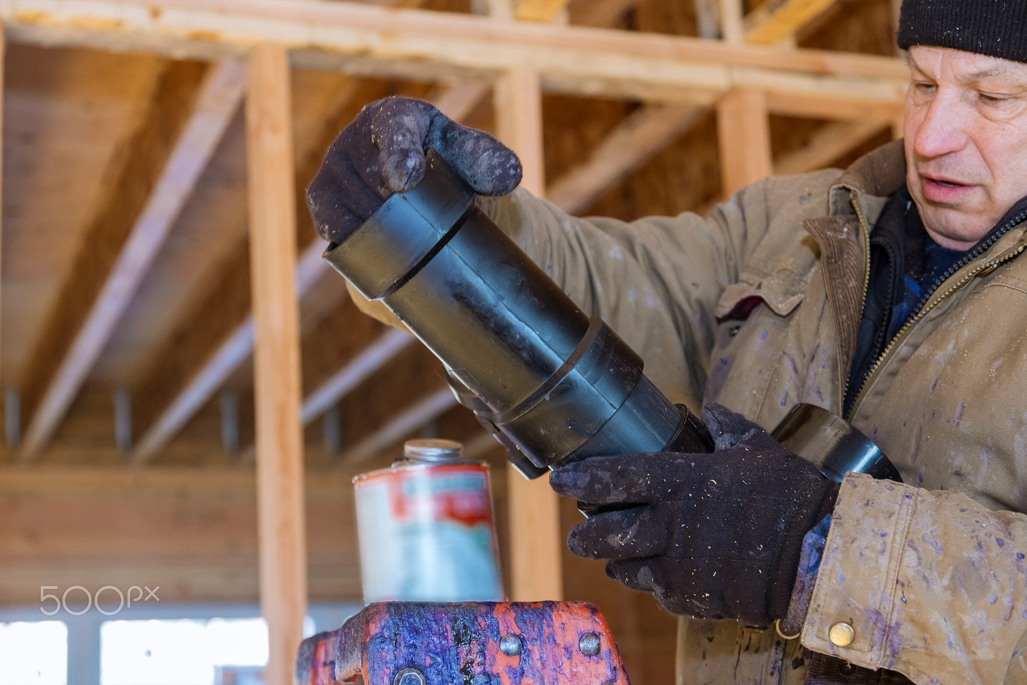 Plumber glue pipe, a mount new plastic drain under a construction