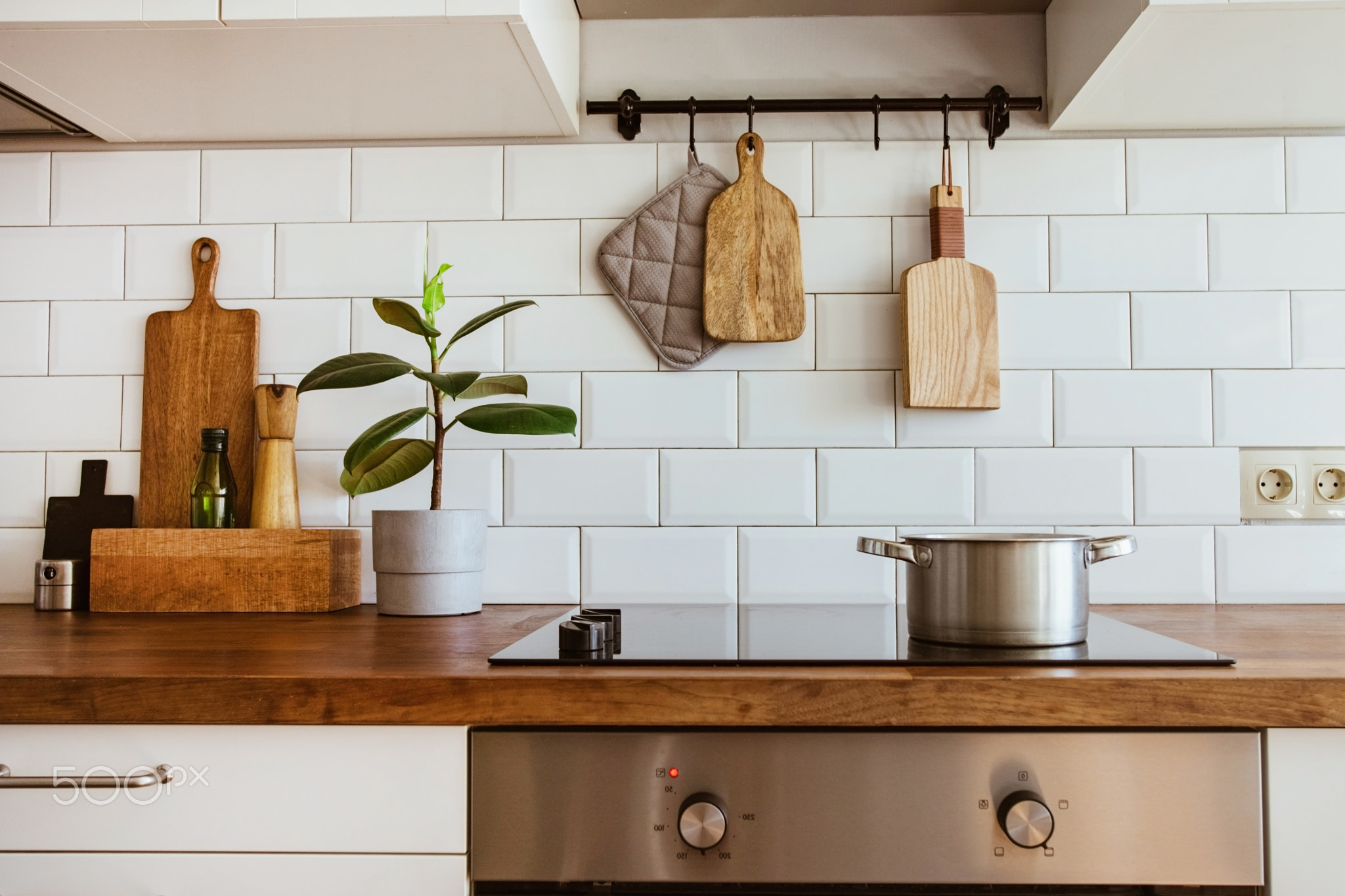 Boiling water in a cooking pot an a pan on a induction stove in the