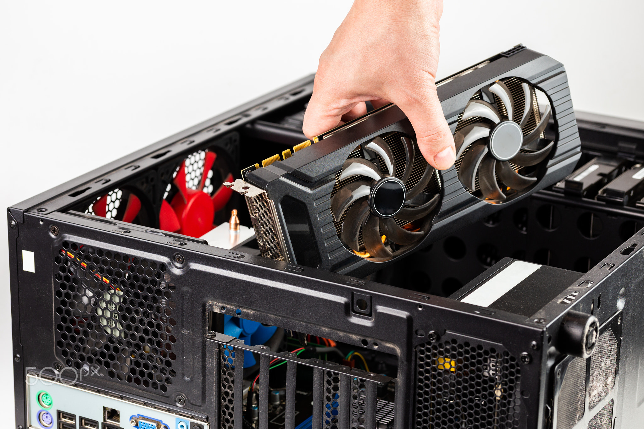 hand plugging a video card while maintenance personal computer
