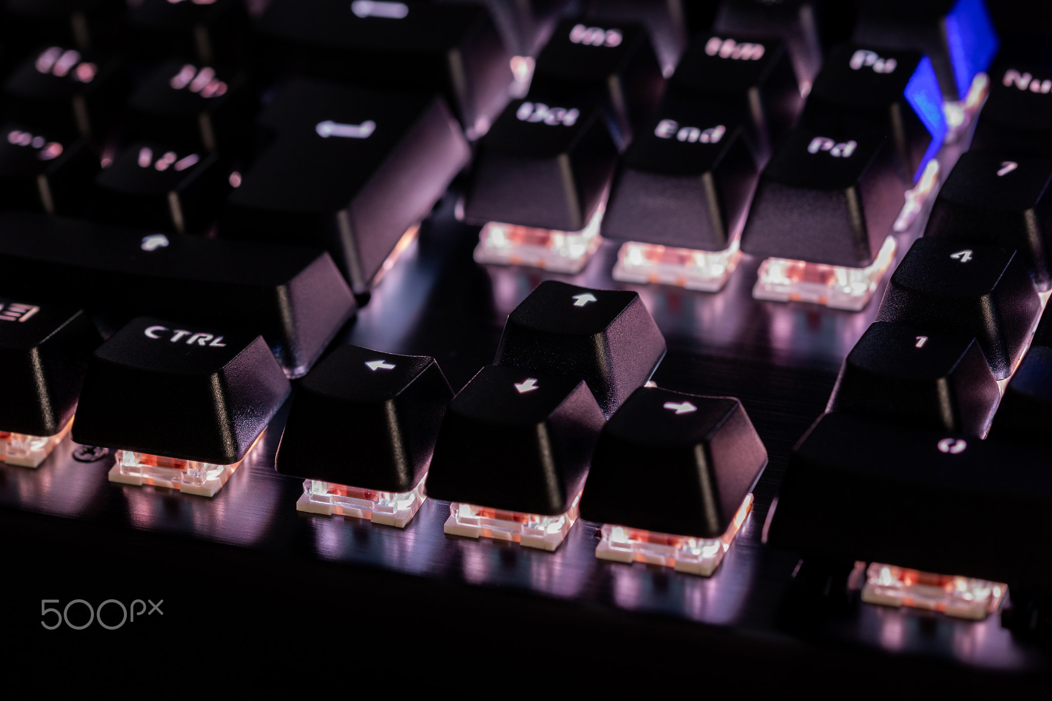 a close-up view of black mechanical pc keyboard with white backlight