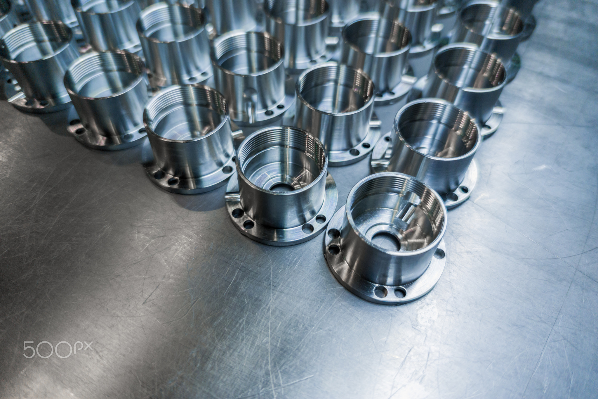 a batch of shiny metal cnc made aerospace parts production - close-up