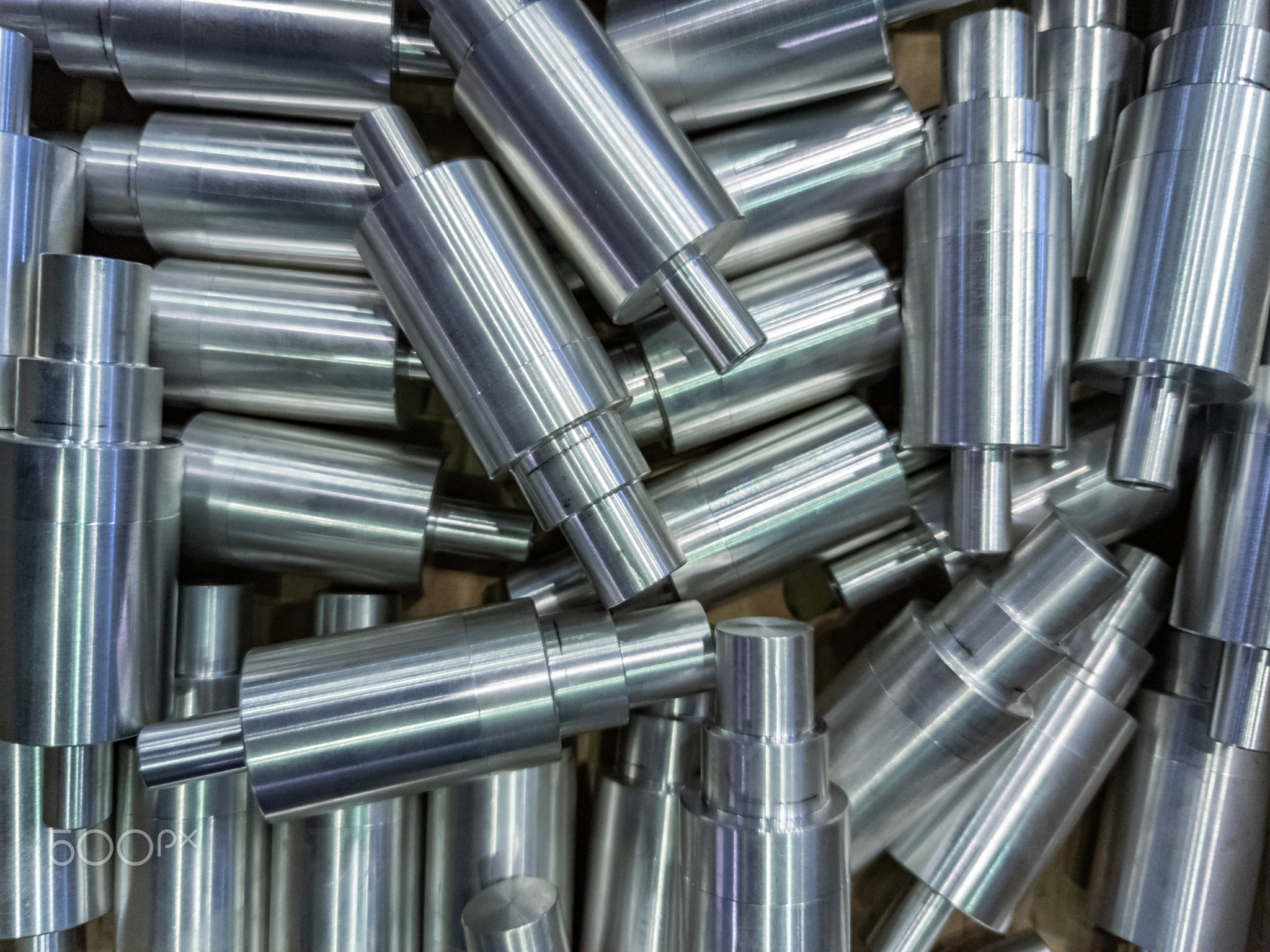 shiny cylindrical aluminium parts close-up full frame industrial