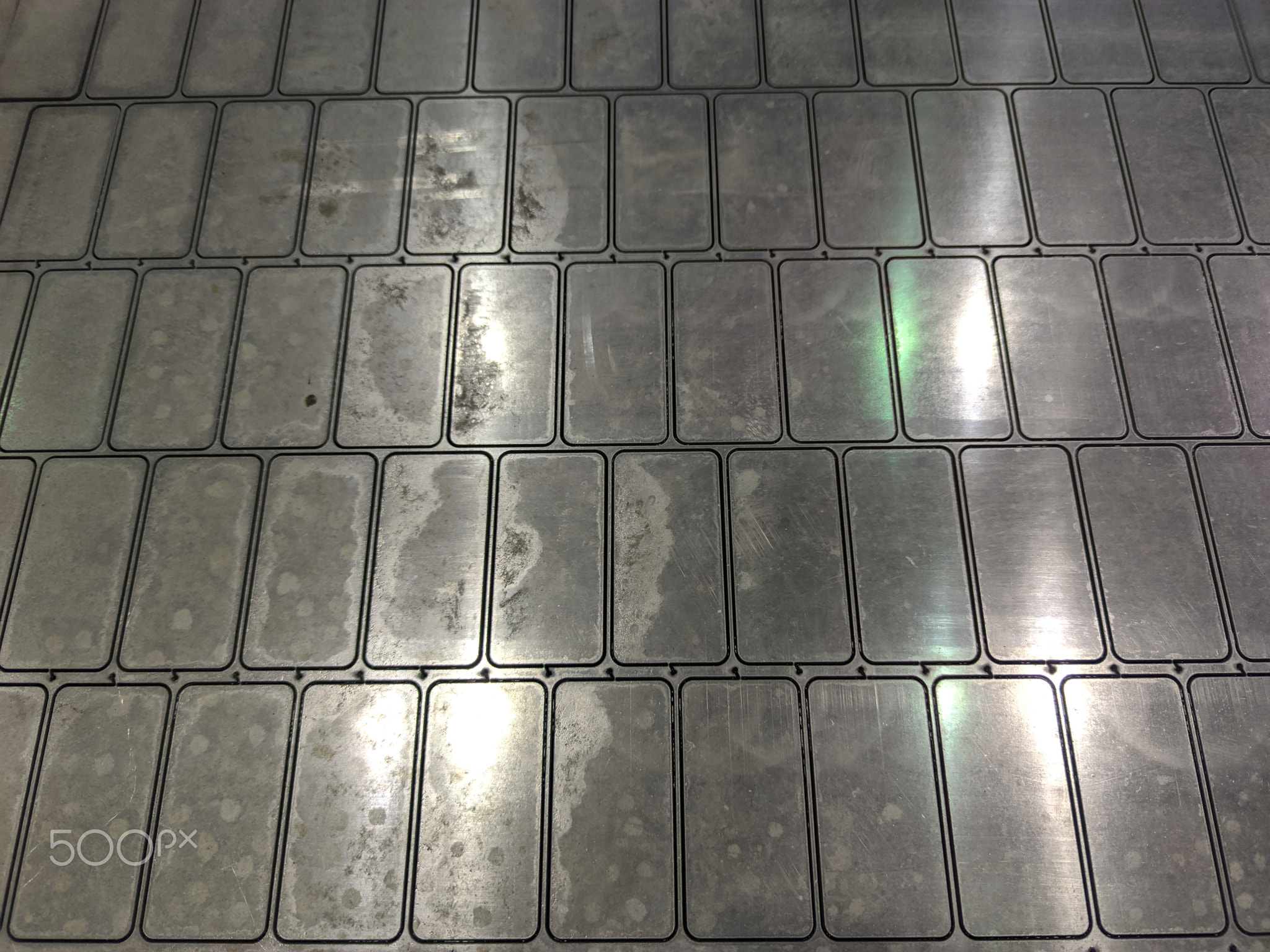 full frame background of waterjet cutted parts in steel sheet