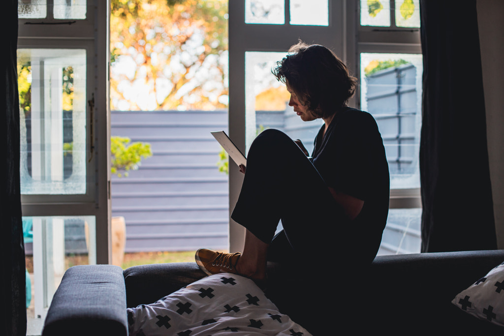 Woman using her laptop to work remotely from home by Rushay Booysen  on 500px.com