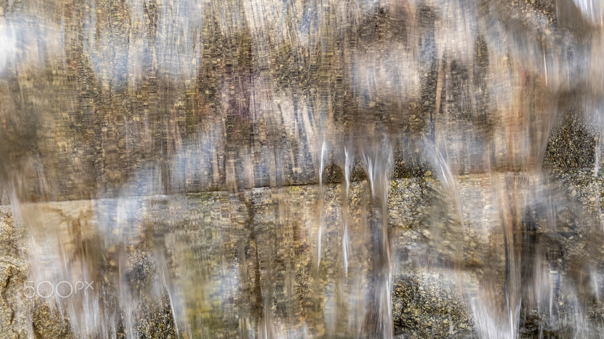 Natural background, water flows down a stone wall