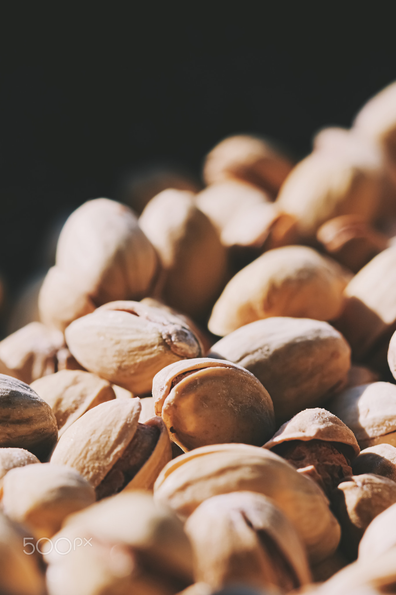 Organic pistachios in the sun, healthy food and snack background