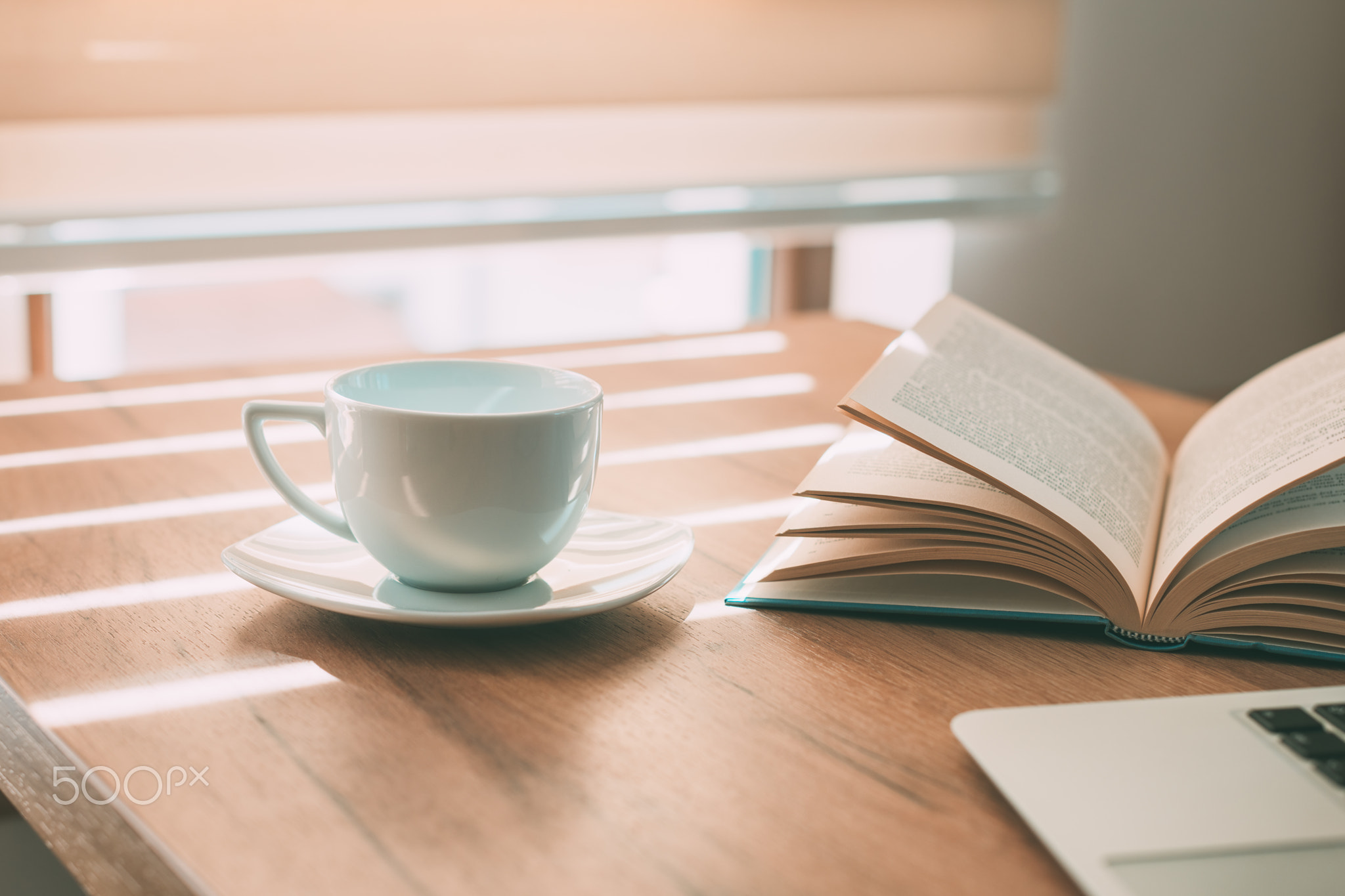 Enjoyable home office workspace with coffee cup and open book