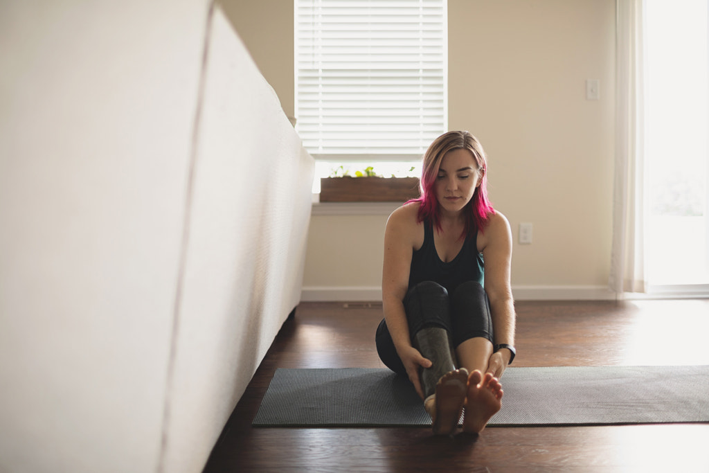 Amputee Woman Sitting on Yoga Mat in Living Room, St. Charles, MO, USA by Nadia M on 500px.com