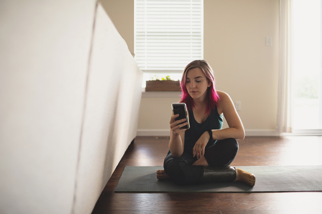 Amputee Woman Sitting on Yoga Mat on phone, St. Charles, MO, USA by Nadia M on 500px.com