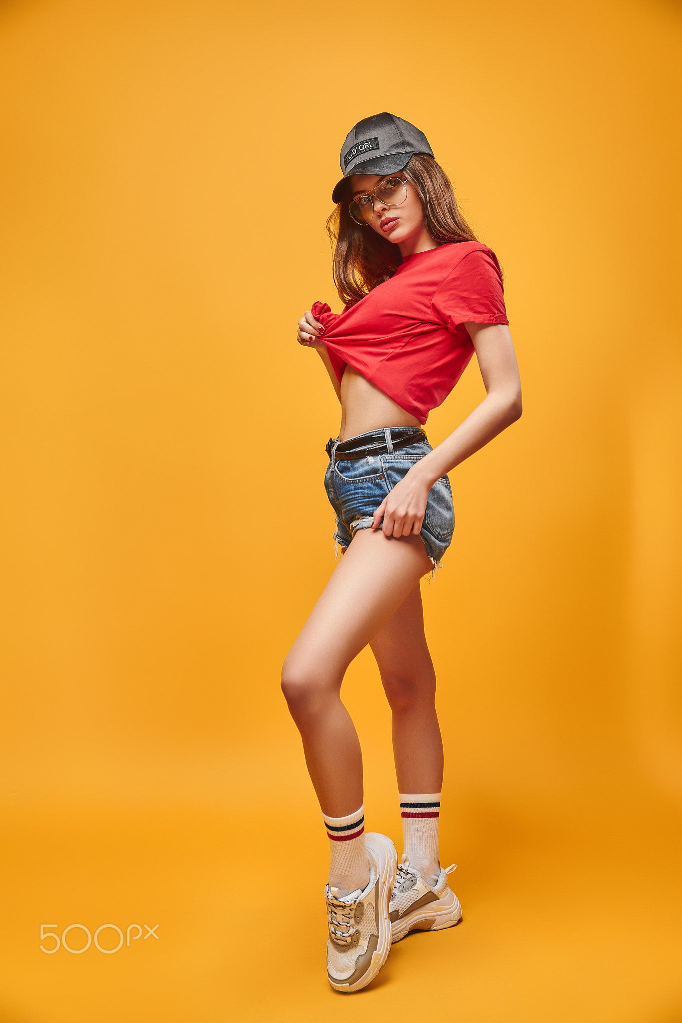 full body portrait sensual brunette wearing in jeans shorts red t