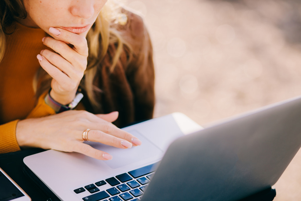 concentrated serious woman entrepreneur work on laptop outdoors in by Avanti on 500px.com