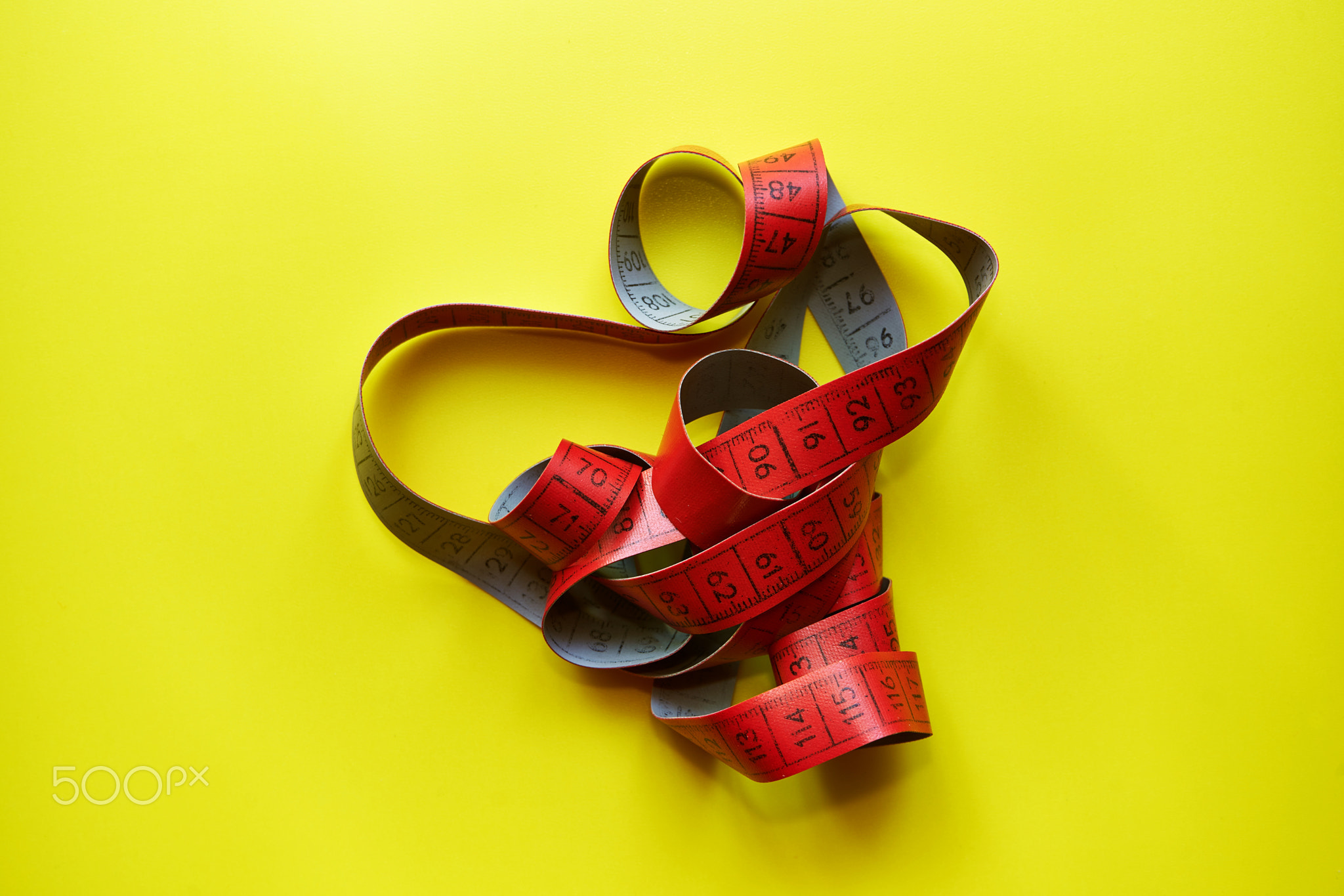 Tape measure on a yellow background