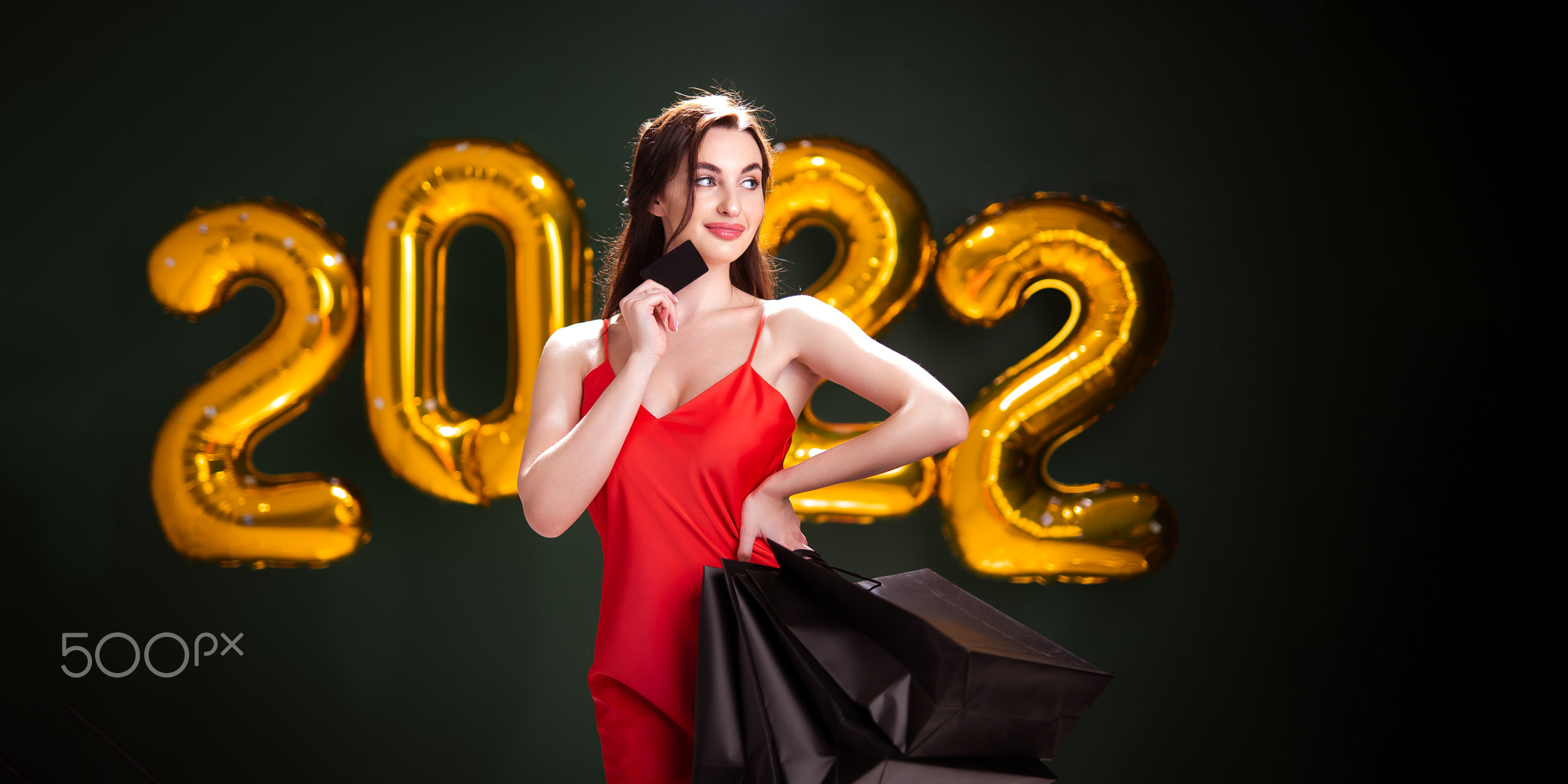 New Year shopping. Black Friday. 2022 air gold balloons. Woman with