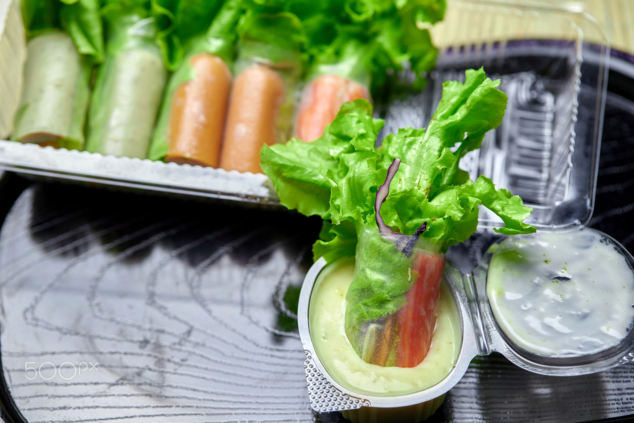 The fresh salad rolls in the plastic container