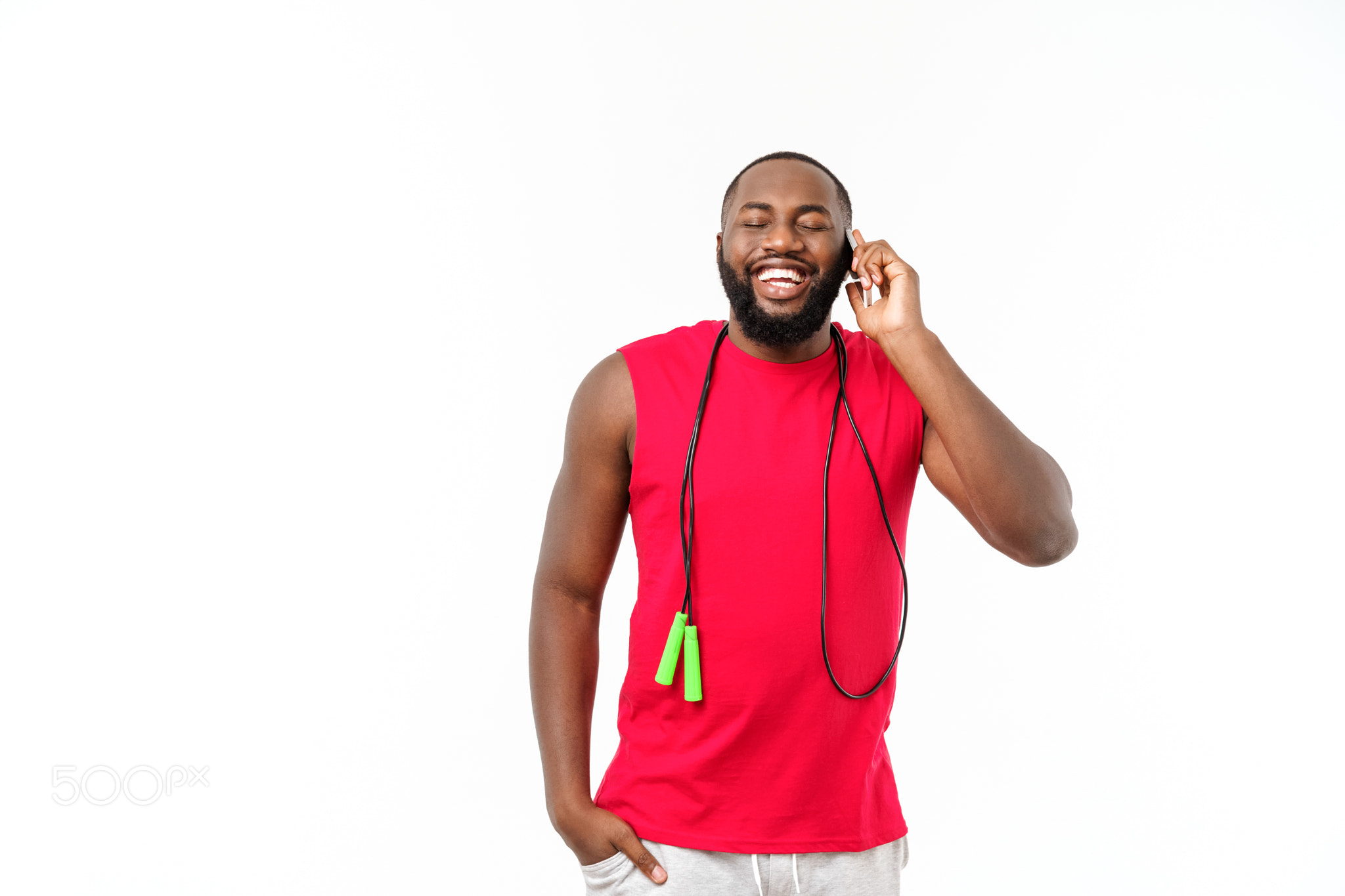 Mature fit African American man talking on mobile and holding elastic