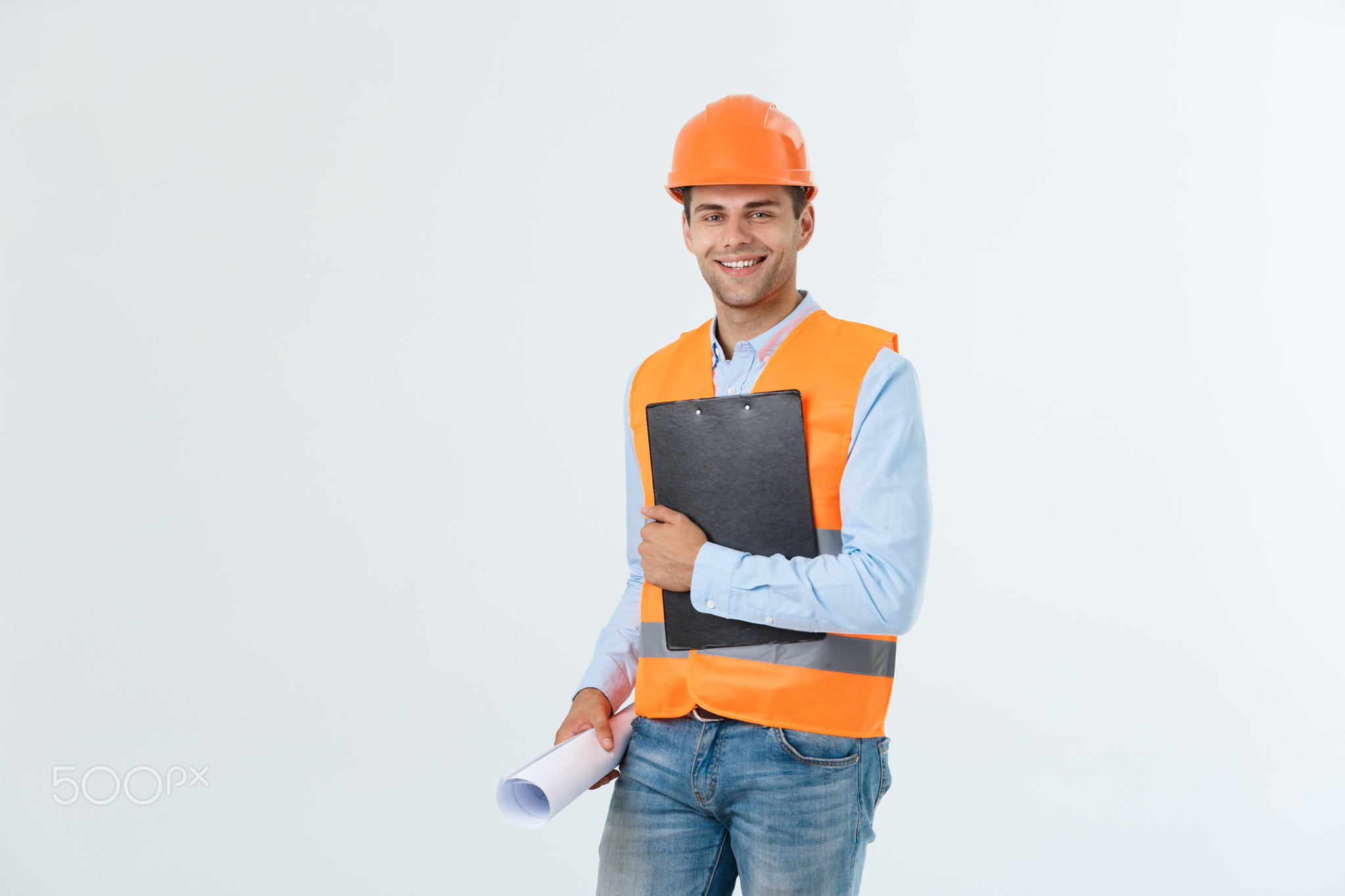 Young engineer smiling isolated on white background.