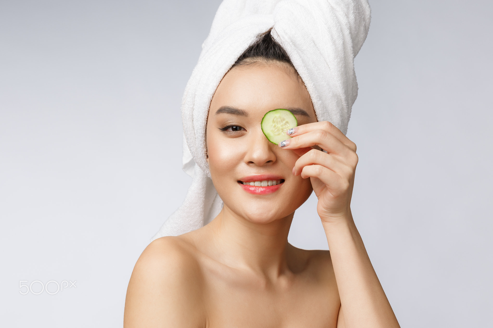 Beauty young asian women skin care image with cucumber on white