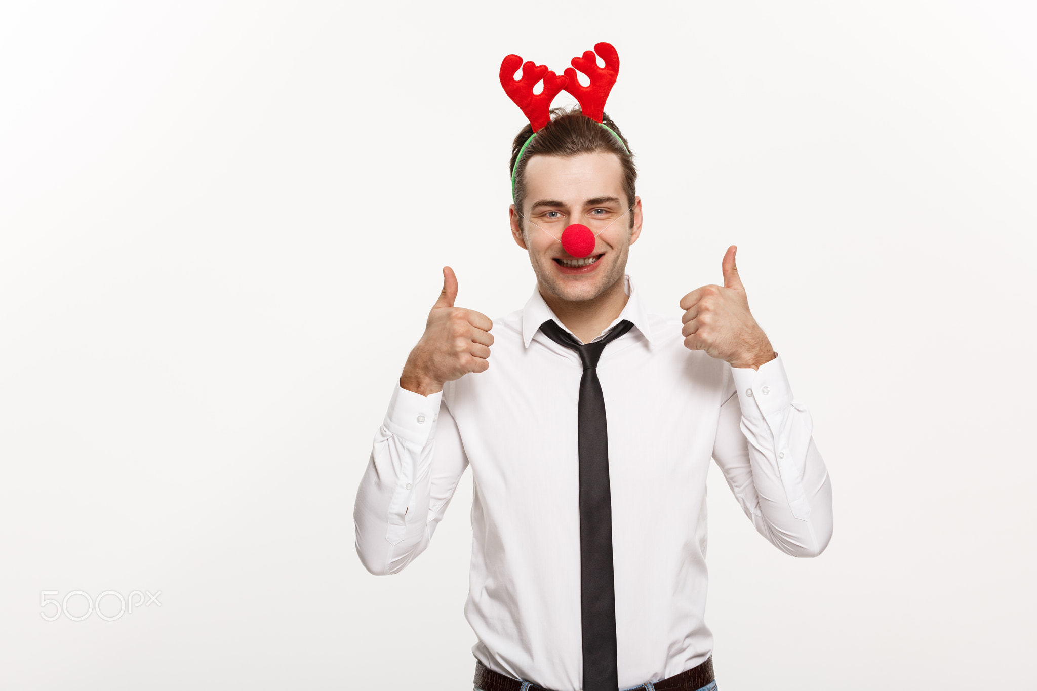Christmas Concept - Handsome Business man wearing reindeer hairband