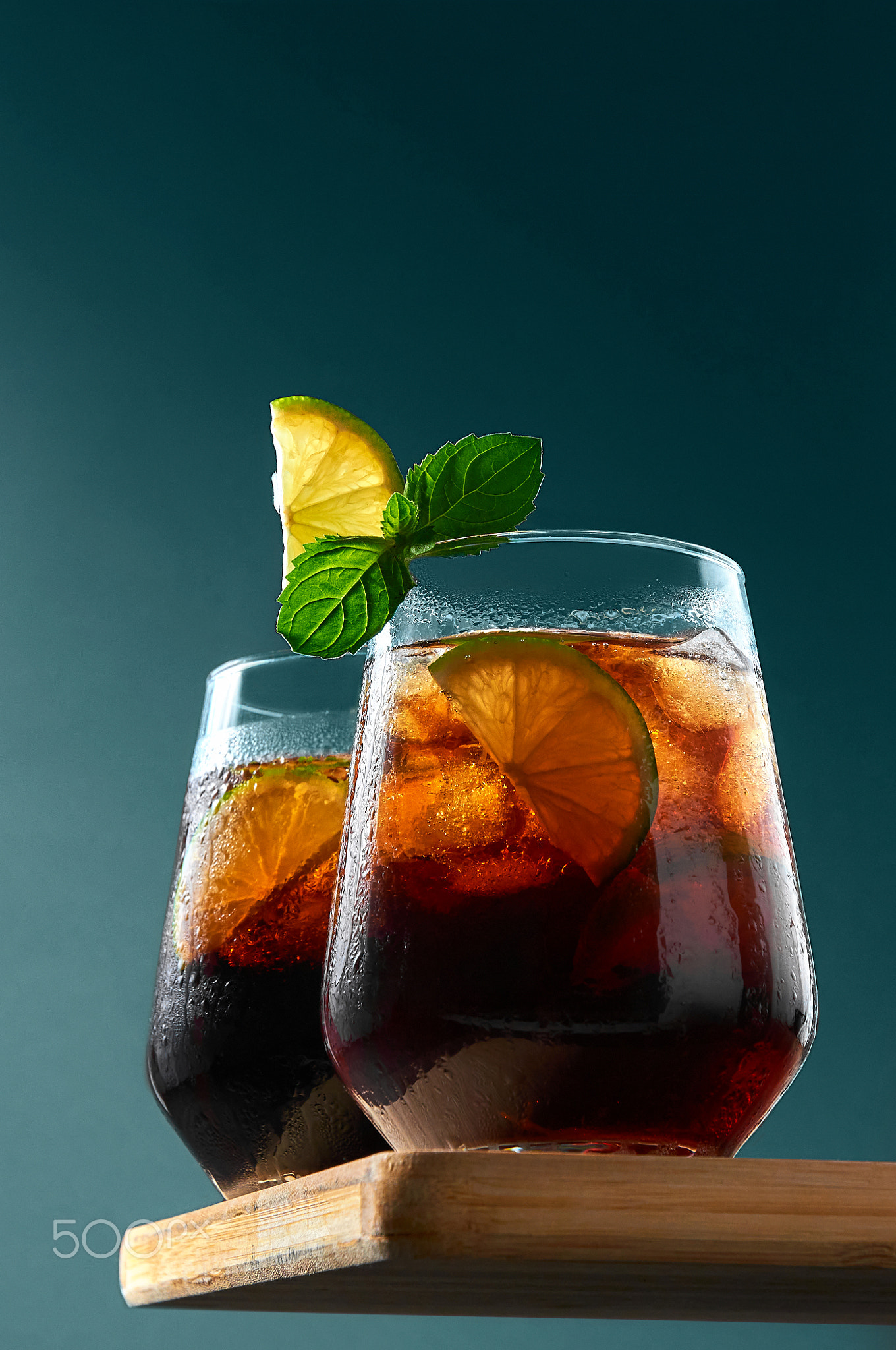 Cuba Libre or Long Island Cocktail with rum, cola and lime in glasses