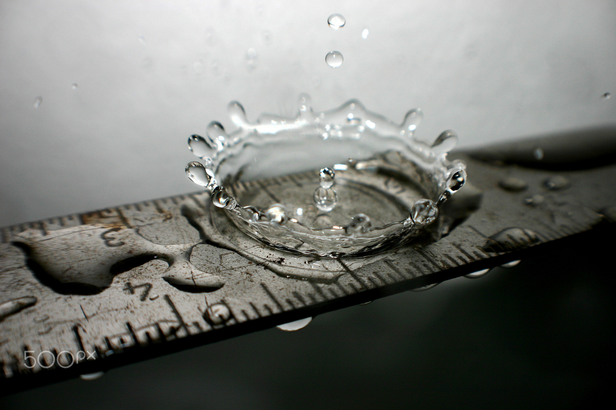 Water splashes on a silver ruler