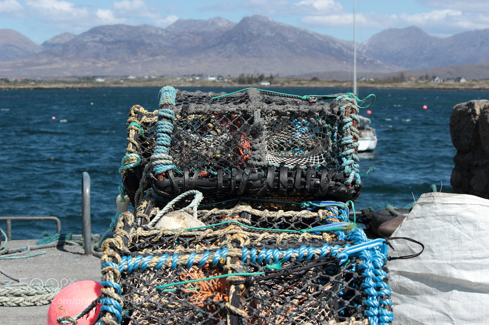 Canon EF-S 55-250mm F4-5.6 IS II sample photo. Particular fishing cages near photography