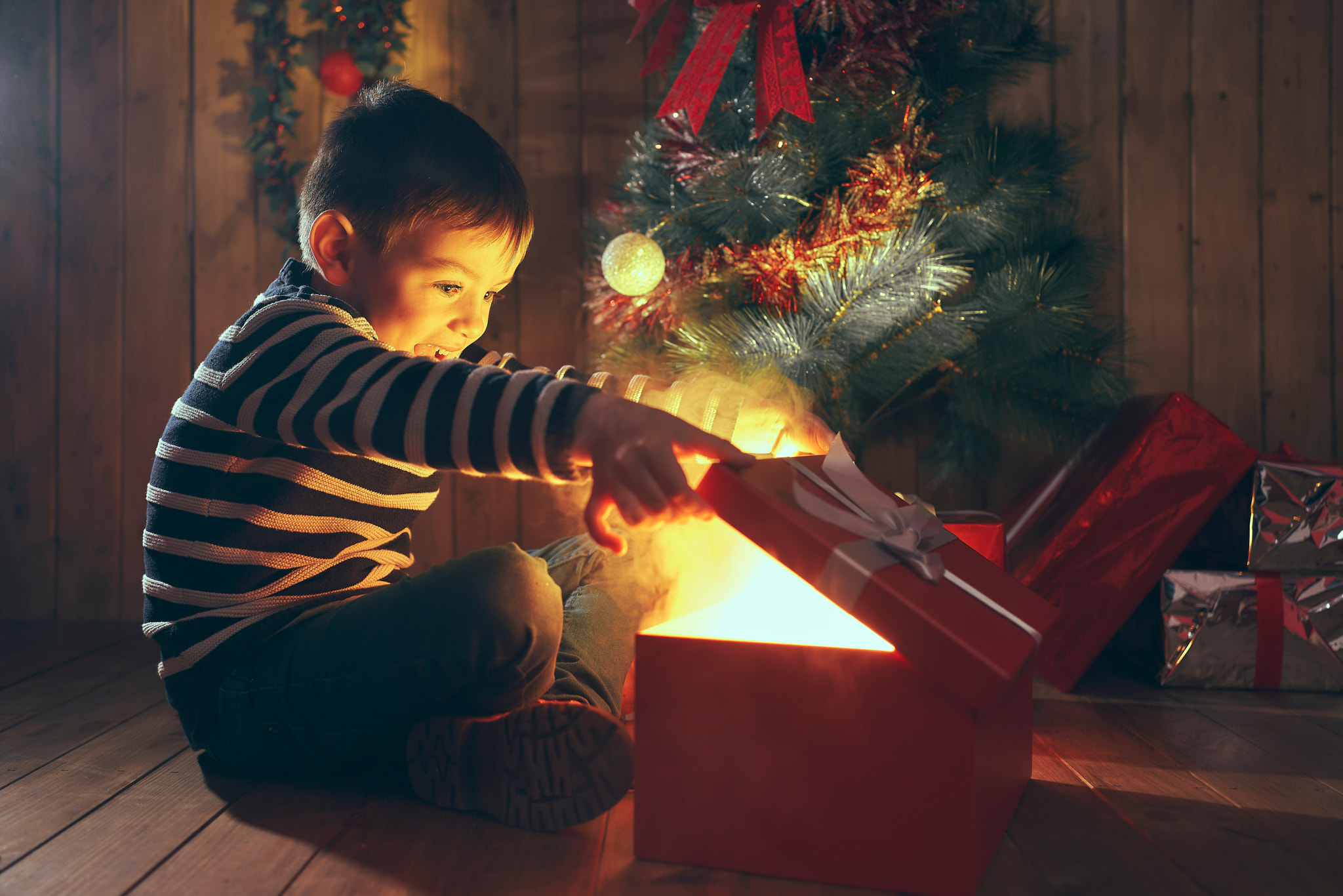 Boy opening magic Christmas gift box with smoke.Merry christmas.