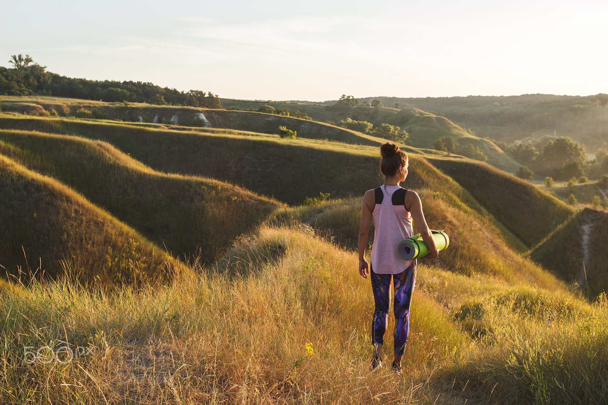 Sporty, beautiful woman on the hills, blurred background