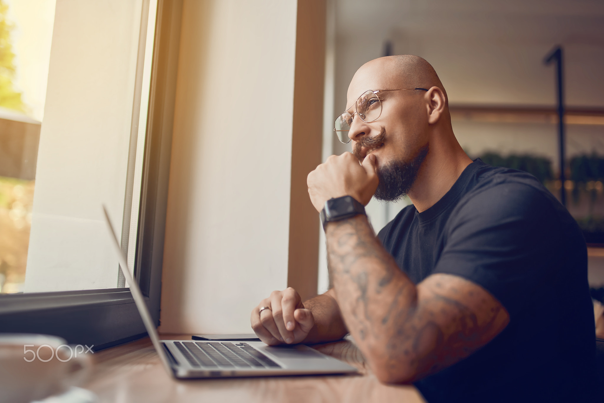 Man working, uses laptop with graphics, charts, diagrams on screen