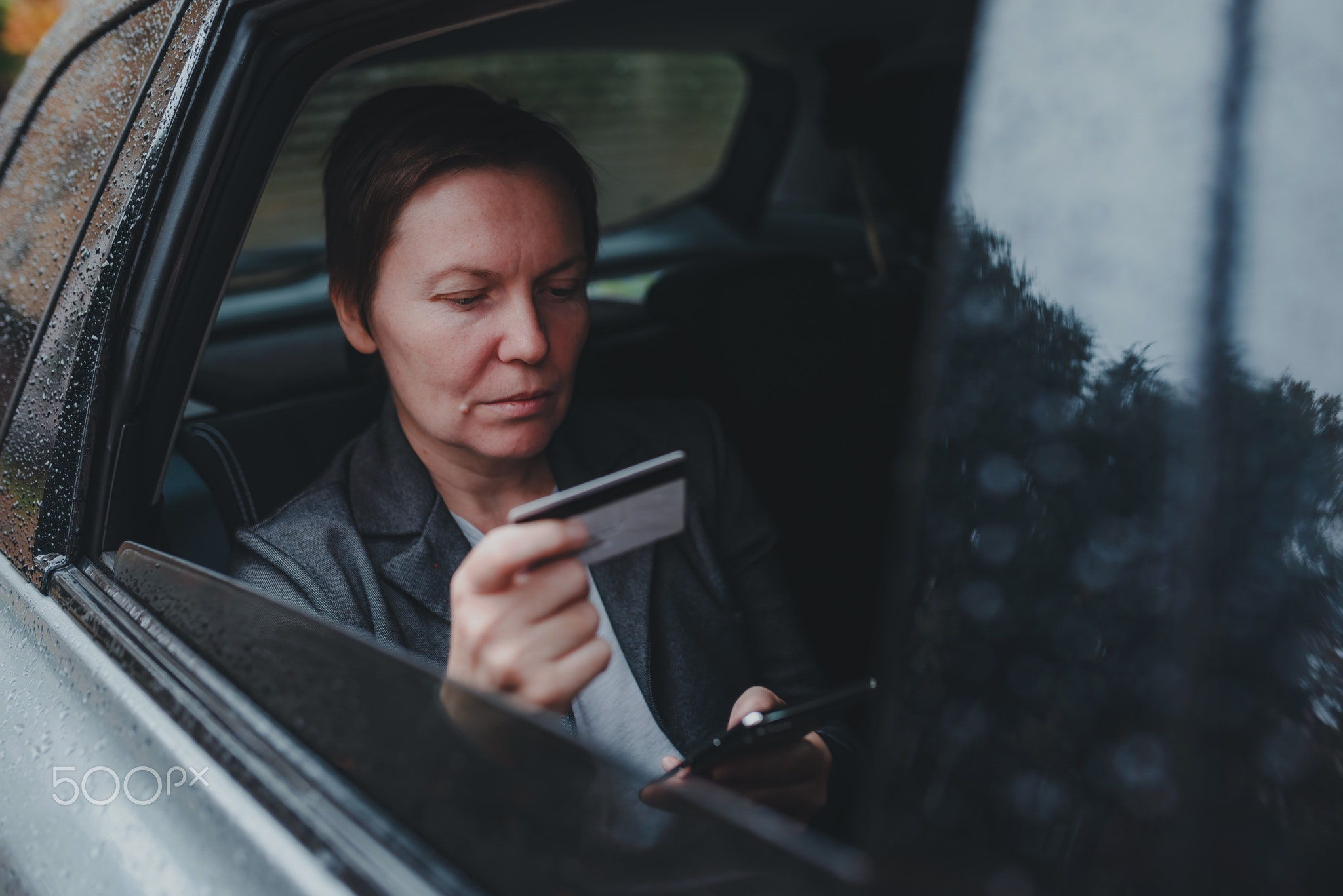 Businesswoman using credit card and mobile smart phone