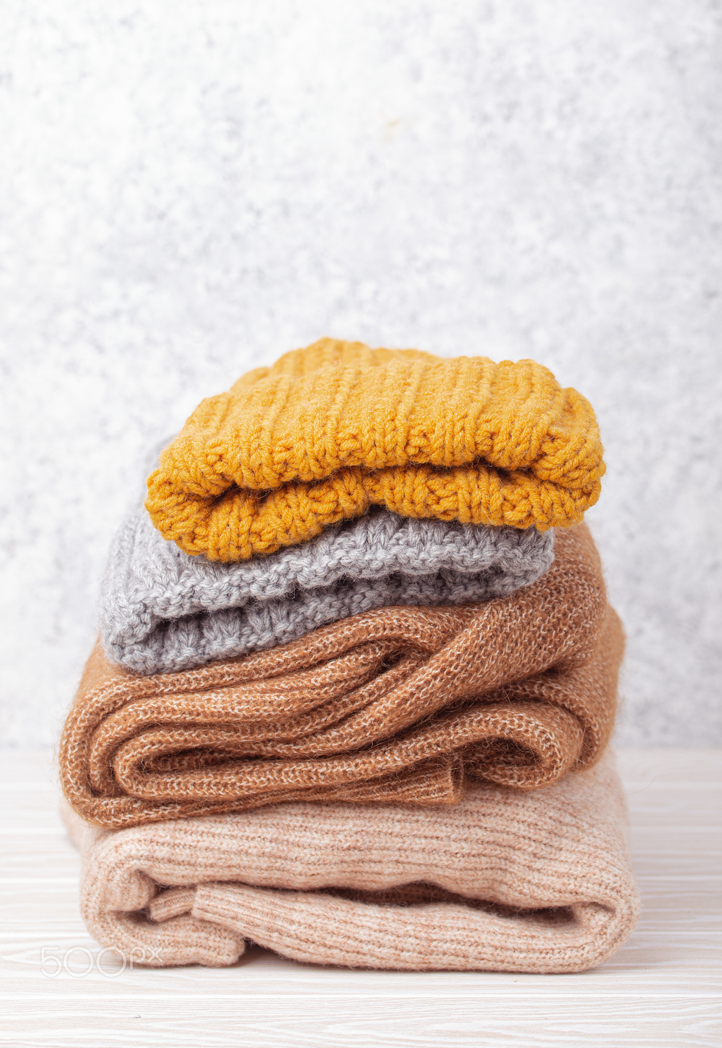 Pile of warm knitted clothes