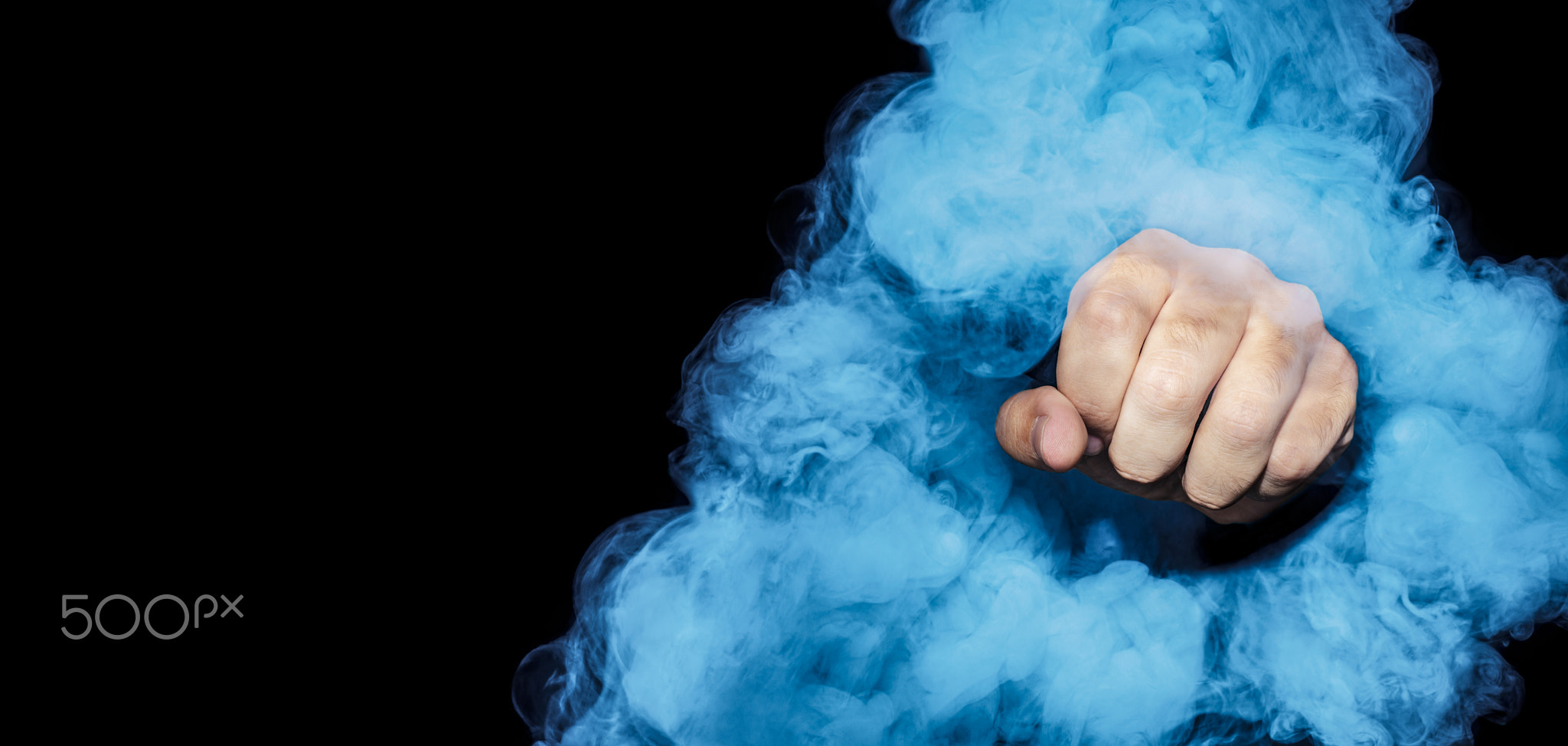 Male fist inside cigarette blue smoke on black background.