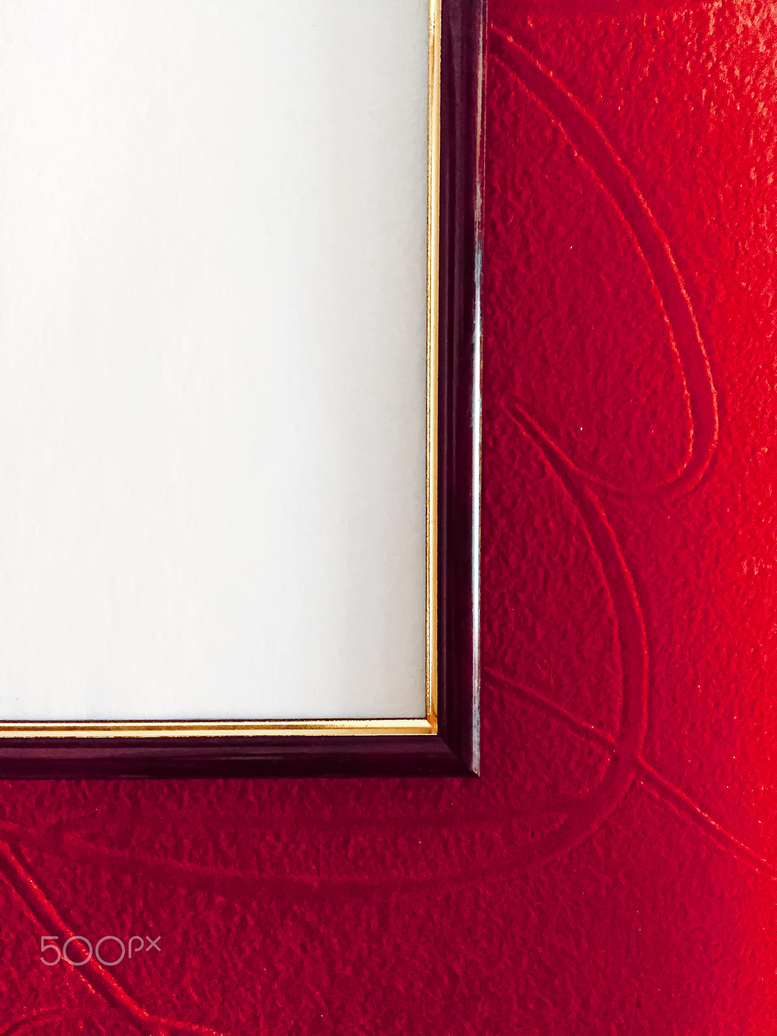 Blank picture frame detail on red background, luxury home decor and