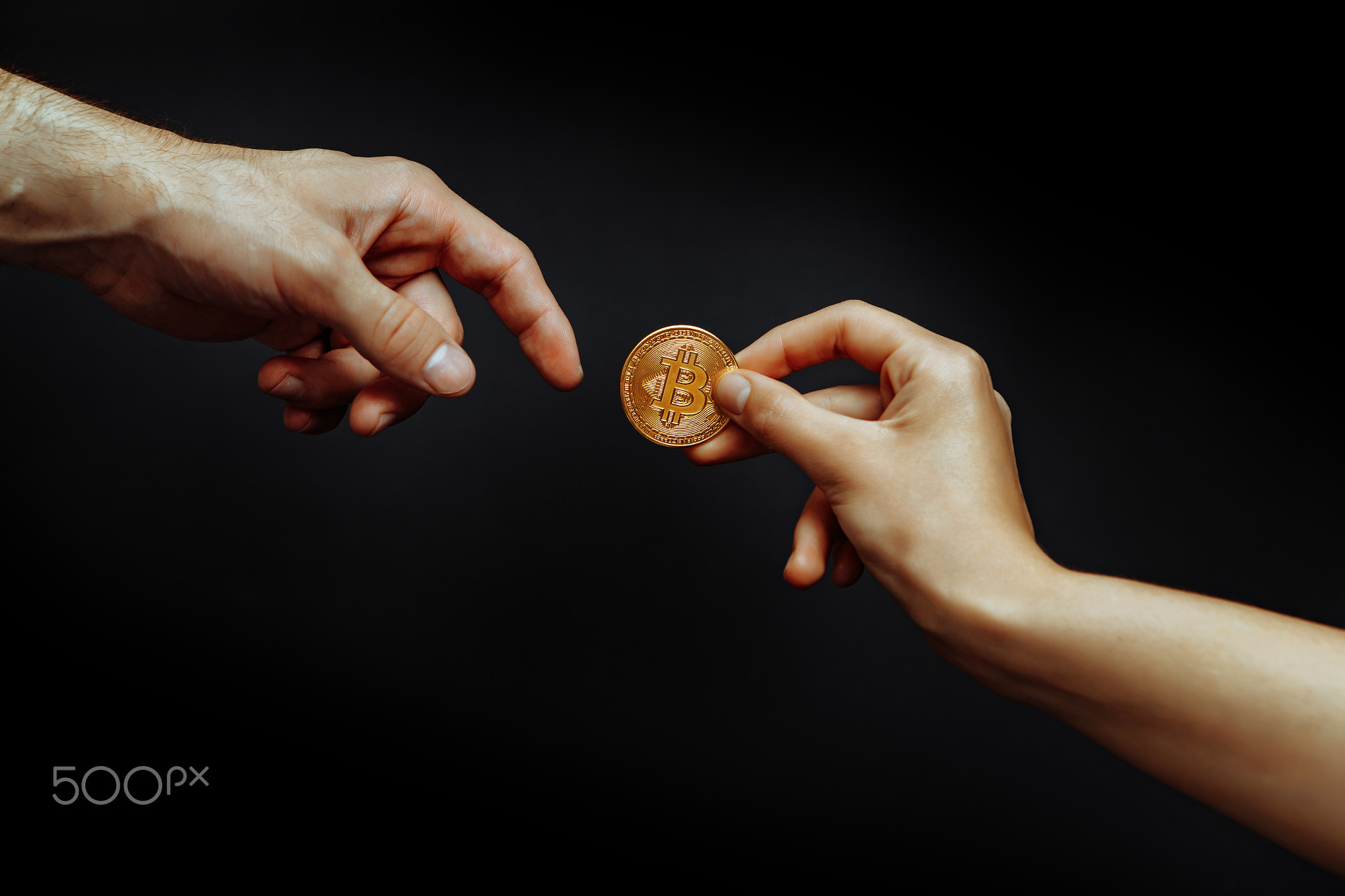 Bitcoin transfer concept from hand to hand.