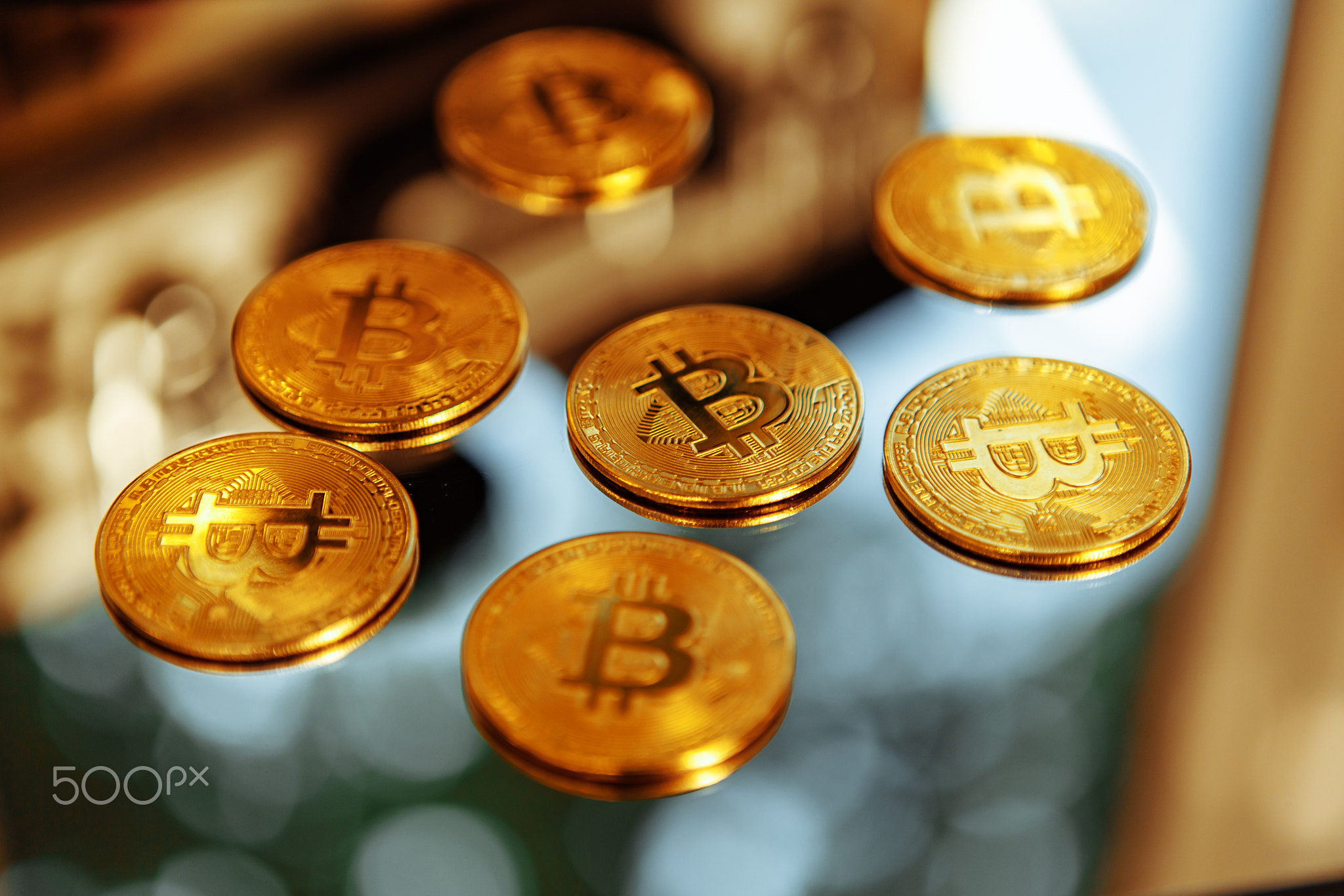 Bitcoins on a mirror background. Crypto fever.