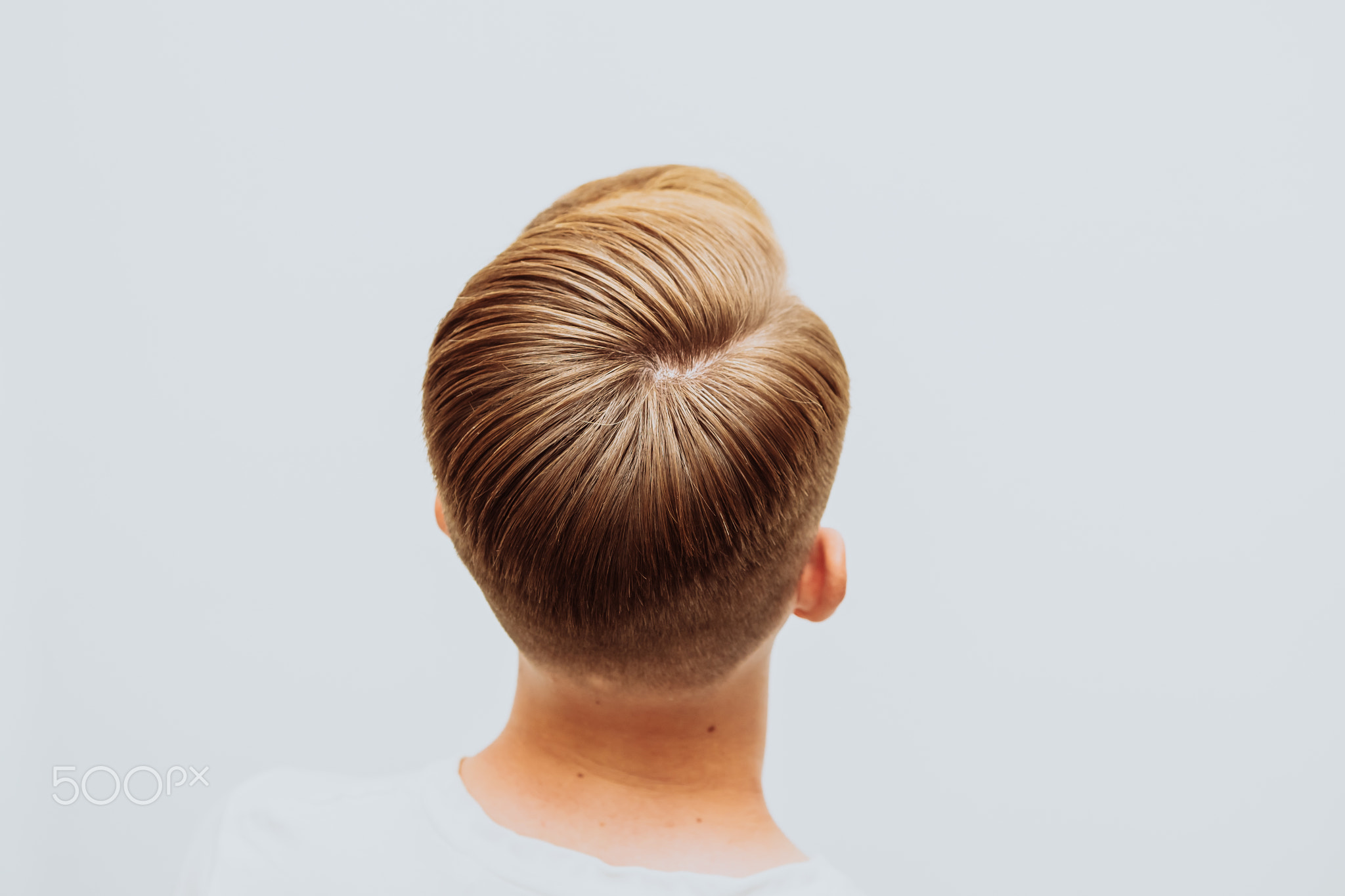 Men's haircut and styling on a white background.
