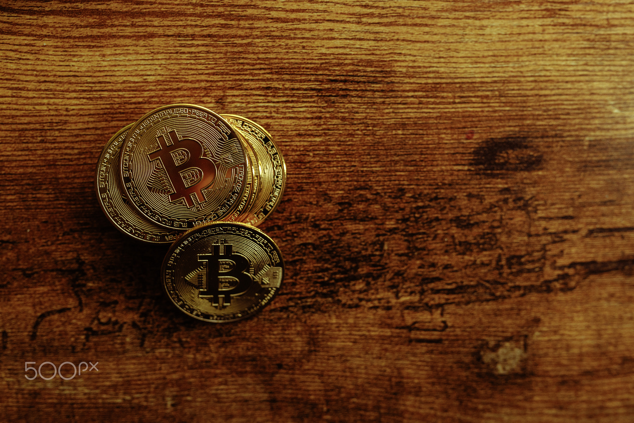 Bitcoins on a wooden background.