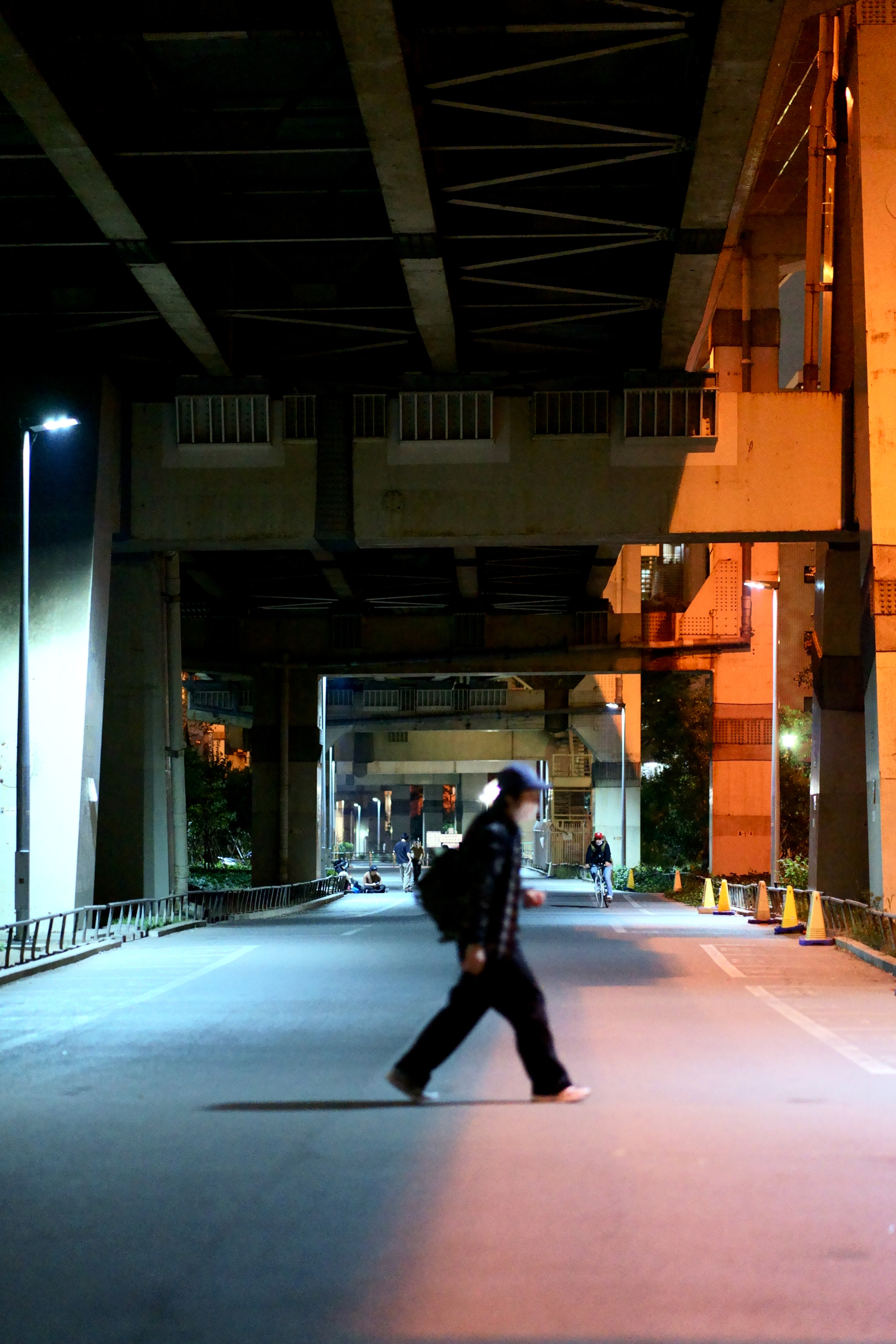 man walking on street at night