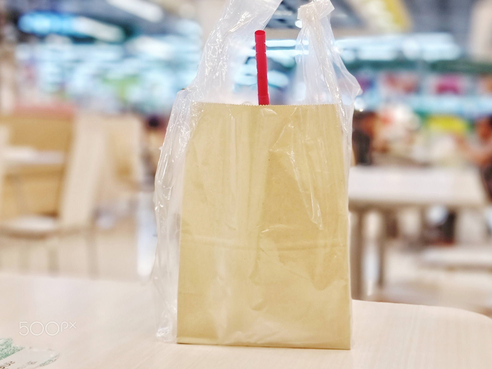 ice coffee in paper bag put on a table at a supermarket in Thailand.