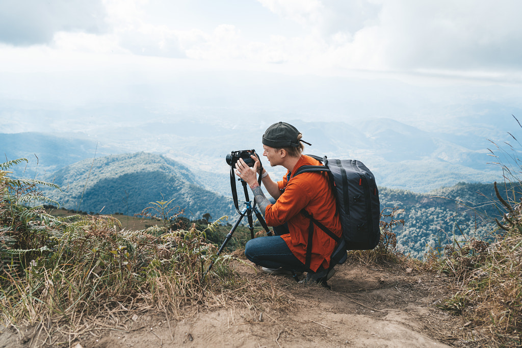 Man making timelapse on a high viewpoint in Doi Inthanon park by Natalie Zotova on 500px.com
