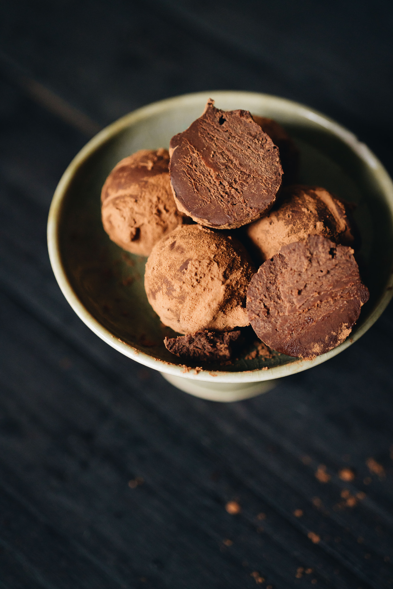 Pieces of chocolate with sweets truffle on a dark background.