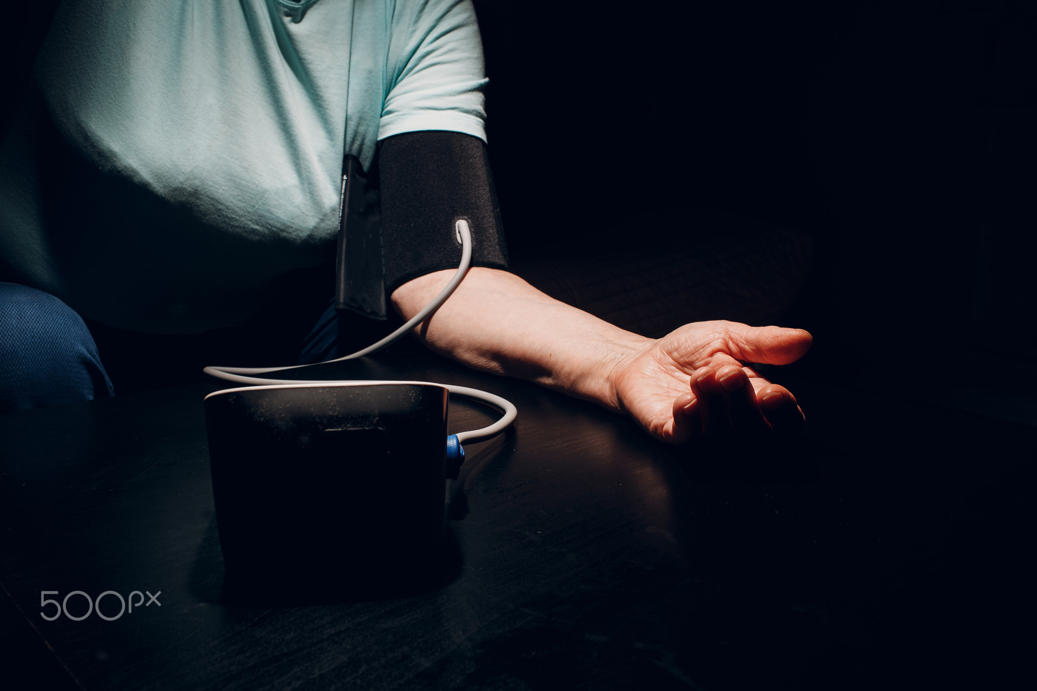 Senior woman taking measures blood pressure at home. Self care of