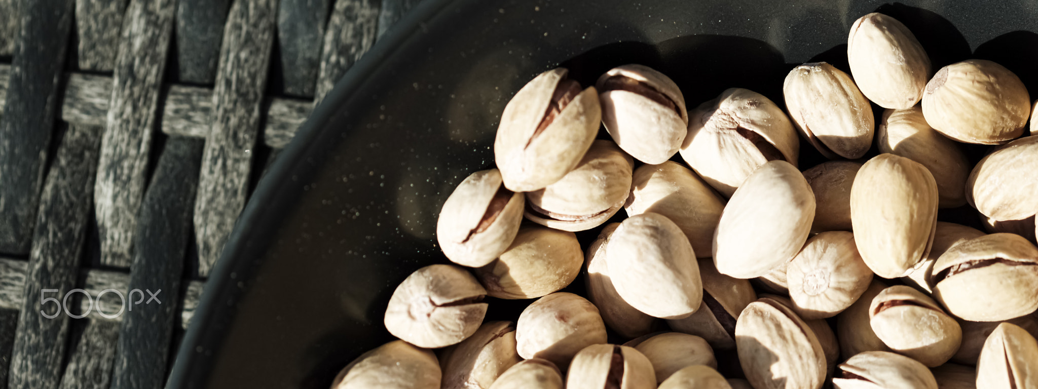 Organic pistachios in the sun, healthy food and snack background