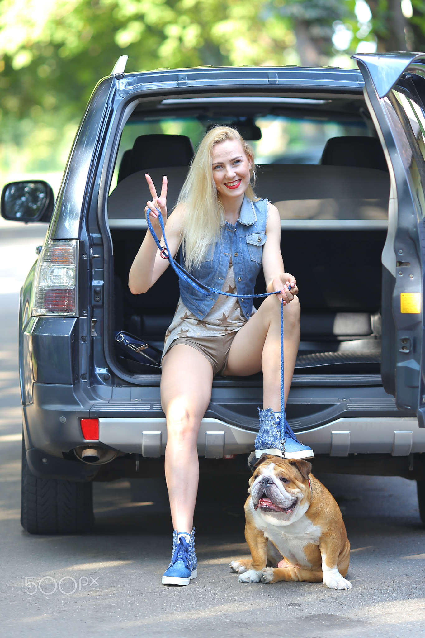 Beautiful female smilling style portrait sitting car american bulldog